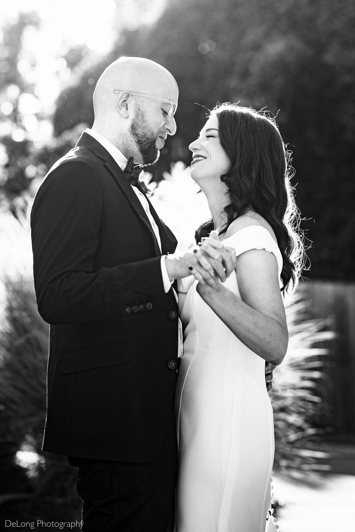Black and white photograph of a bride and groom slow dancing outside Eventide Brewing in Atlanta, GA by Charlotte wedding photographers DeLong Photography