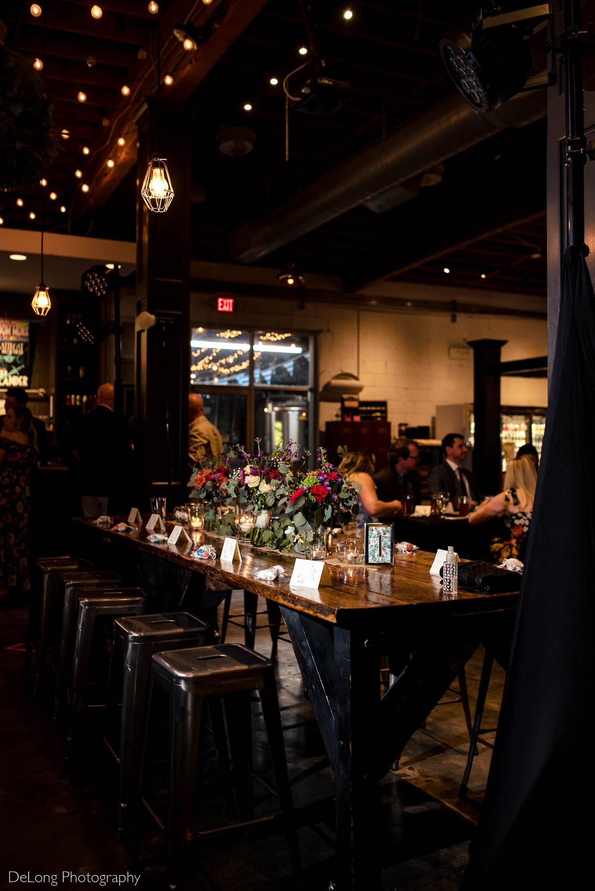 Indoor reception tablescape at Eventide Brewing in Atlanta, GA by Charlotte wedding Photographers DeLong Photography