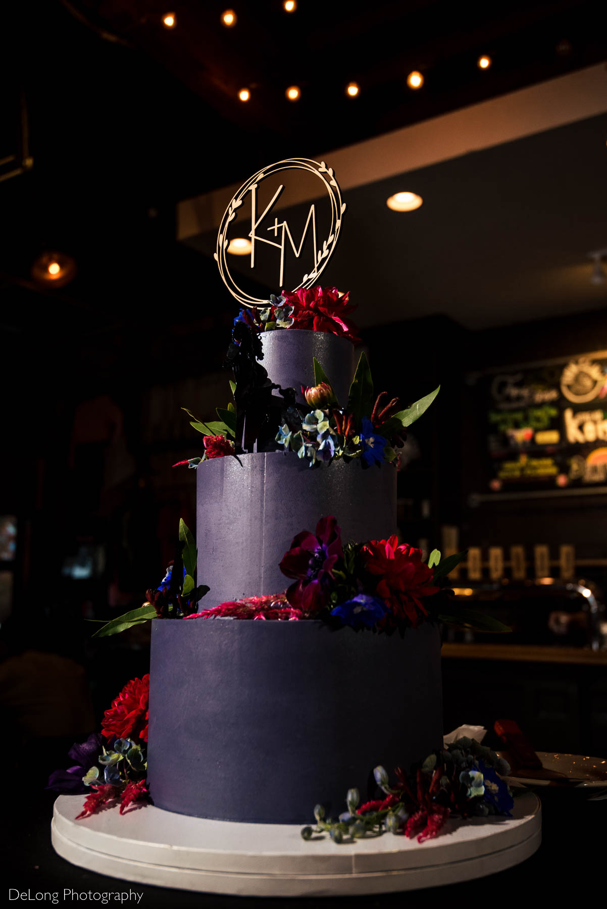 Moody jewel-toned purple wedding cake by Ginger Spice Bakery at Eventide Brewing in Atlanta, GA by Charlotte wedding Photographers DeLong Photography