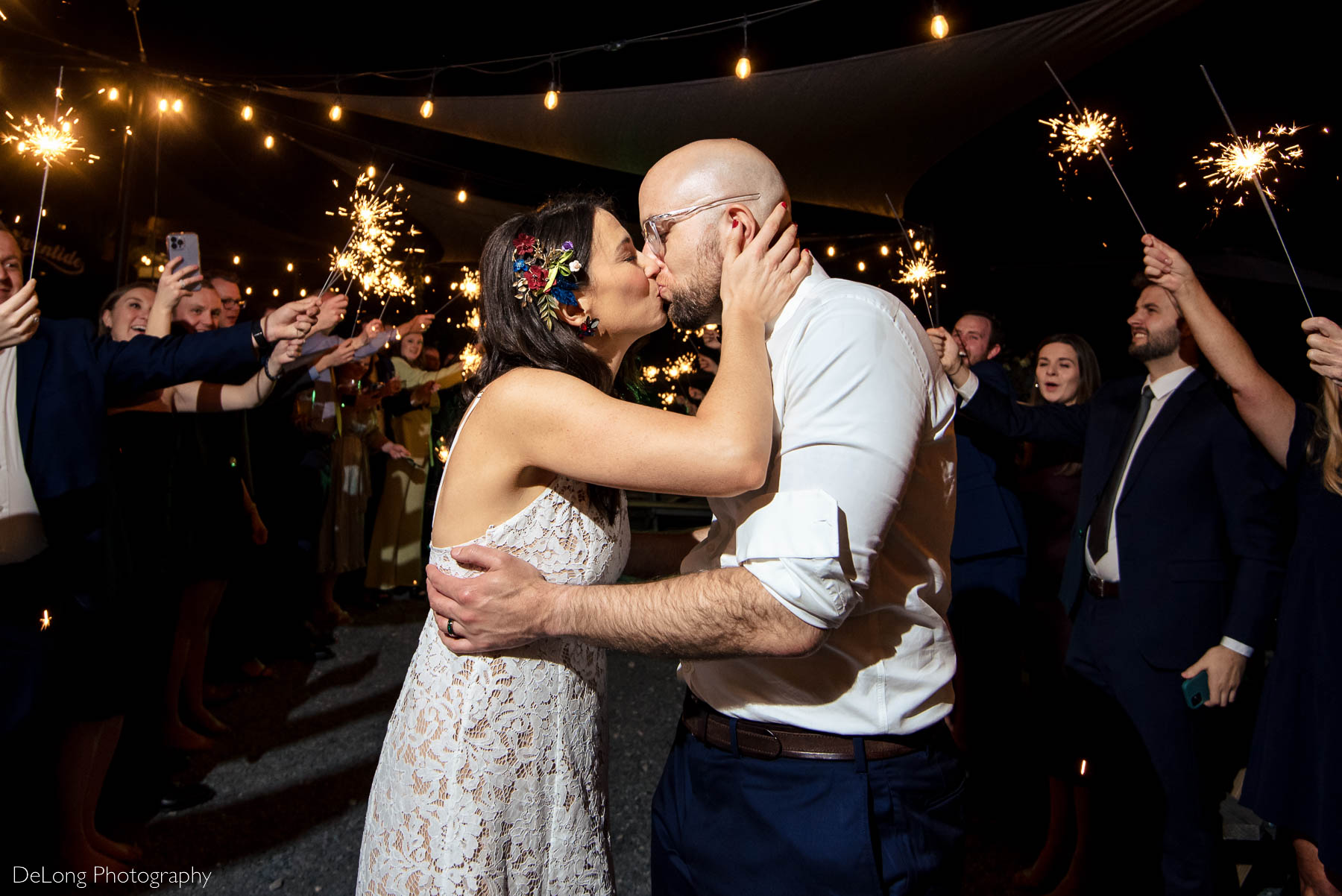Bride and groom kissing during their sparkler exit at Eventide Brewing in Atlanta, GA by Charlotte wedding Photographers DeLong Photography