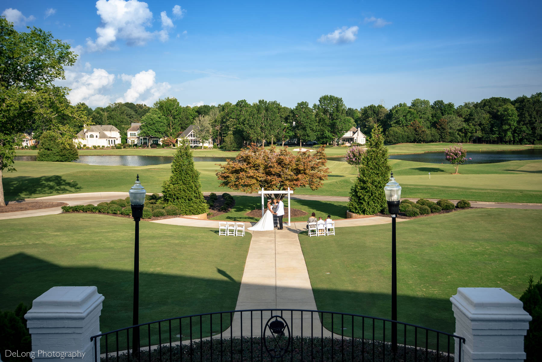 A wide-angle and high perspective photograph of an elopement ceremony at Providence Country Club by Charlotte wedding photographers DeLong Photography