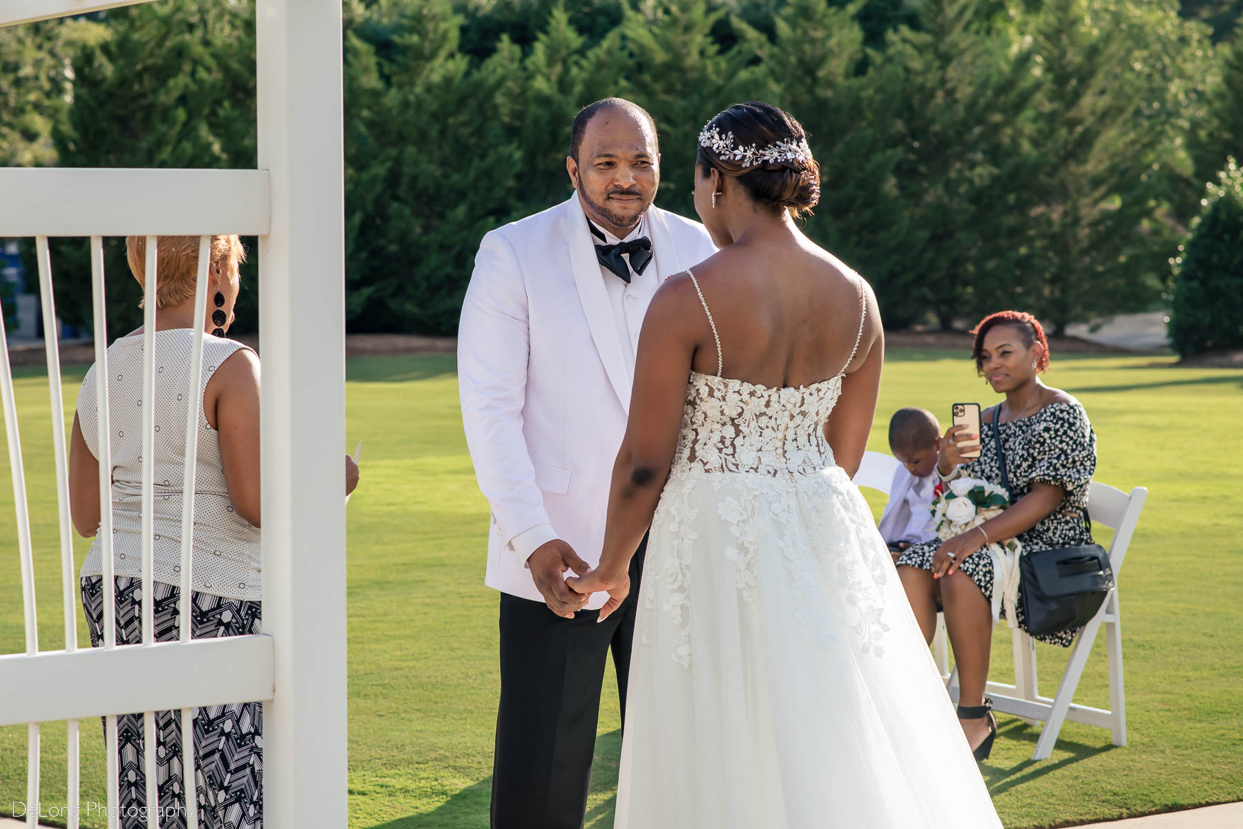 The groom smiling at his bride during their elopement ceremony at Providence Country Club by Charlotte wedding photographers DeLong Photography