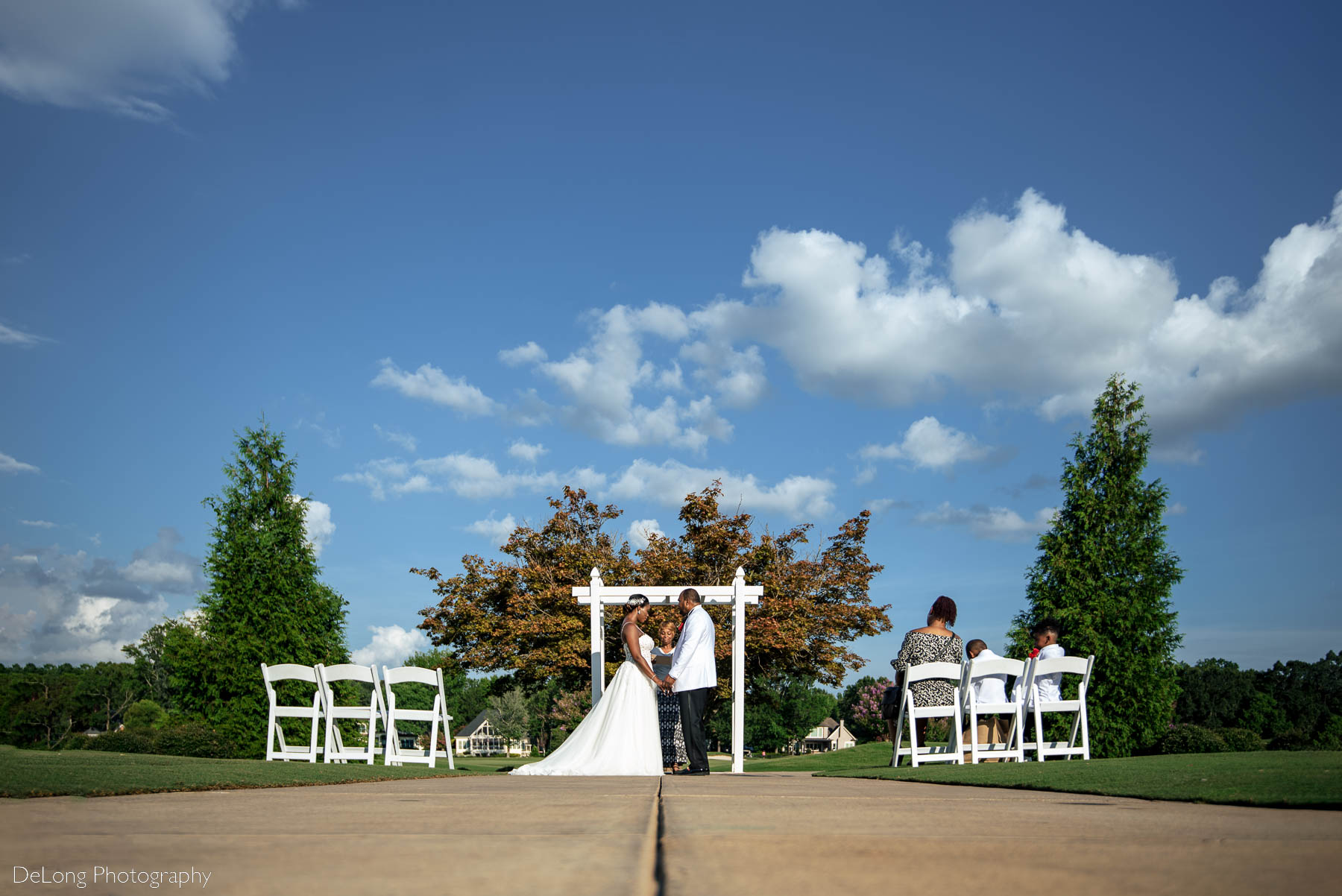 A low perspective image of an elopement ceremony at Providence Country Club by Charlotte wedding photographers DeLong Photography