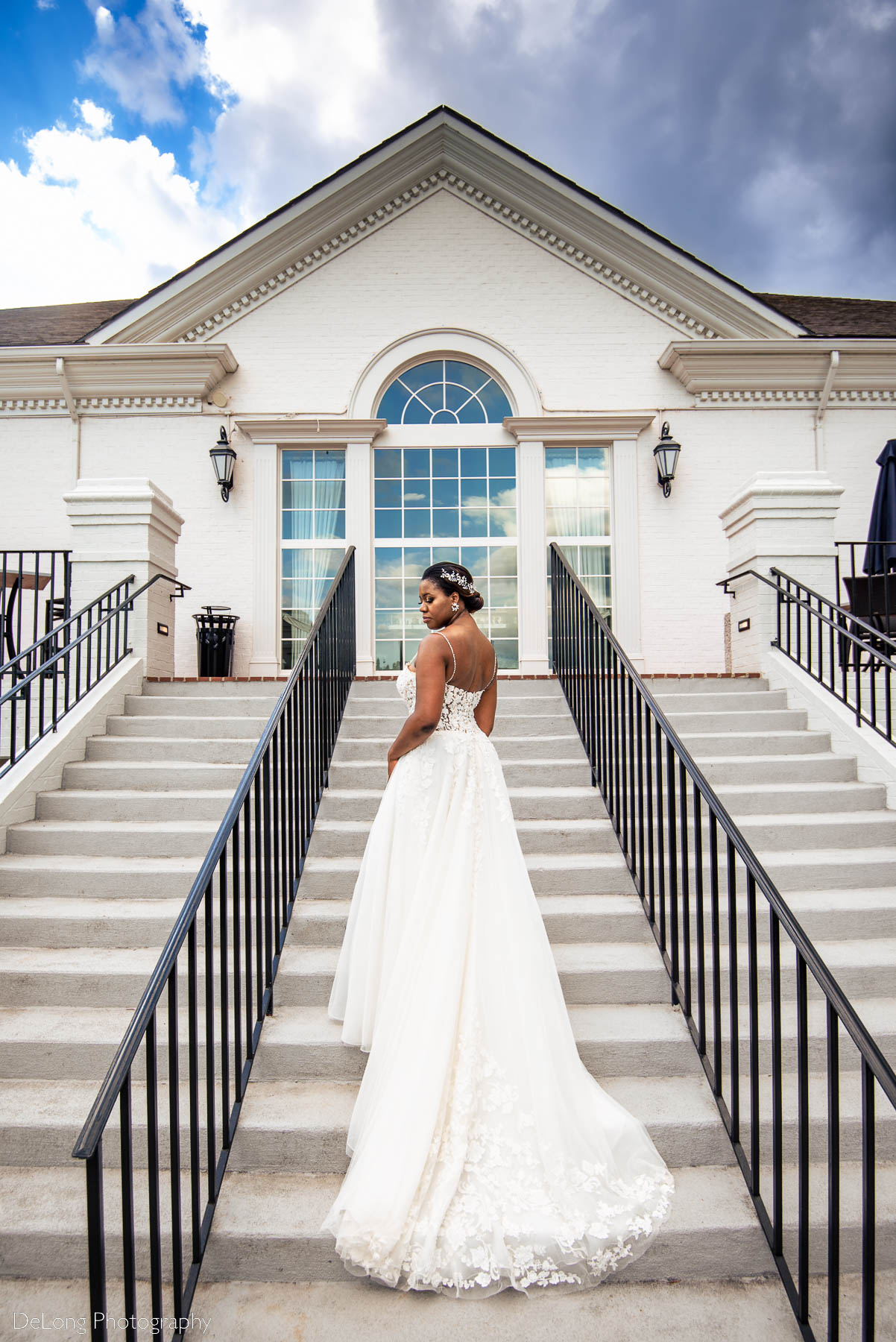 A bridal portrait on the steps at Providence Country Club by Charlotte wedding photographers DeLong Photography