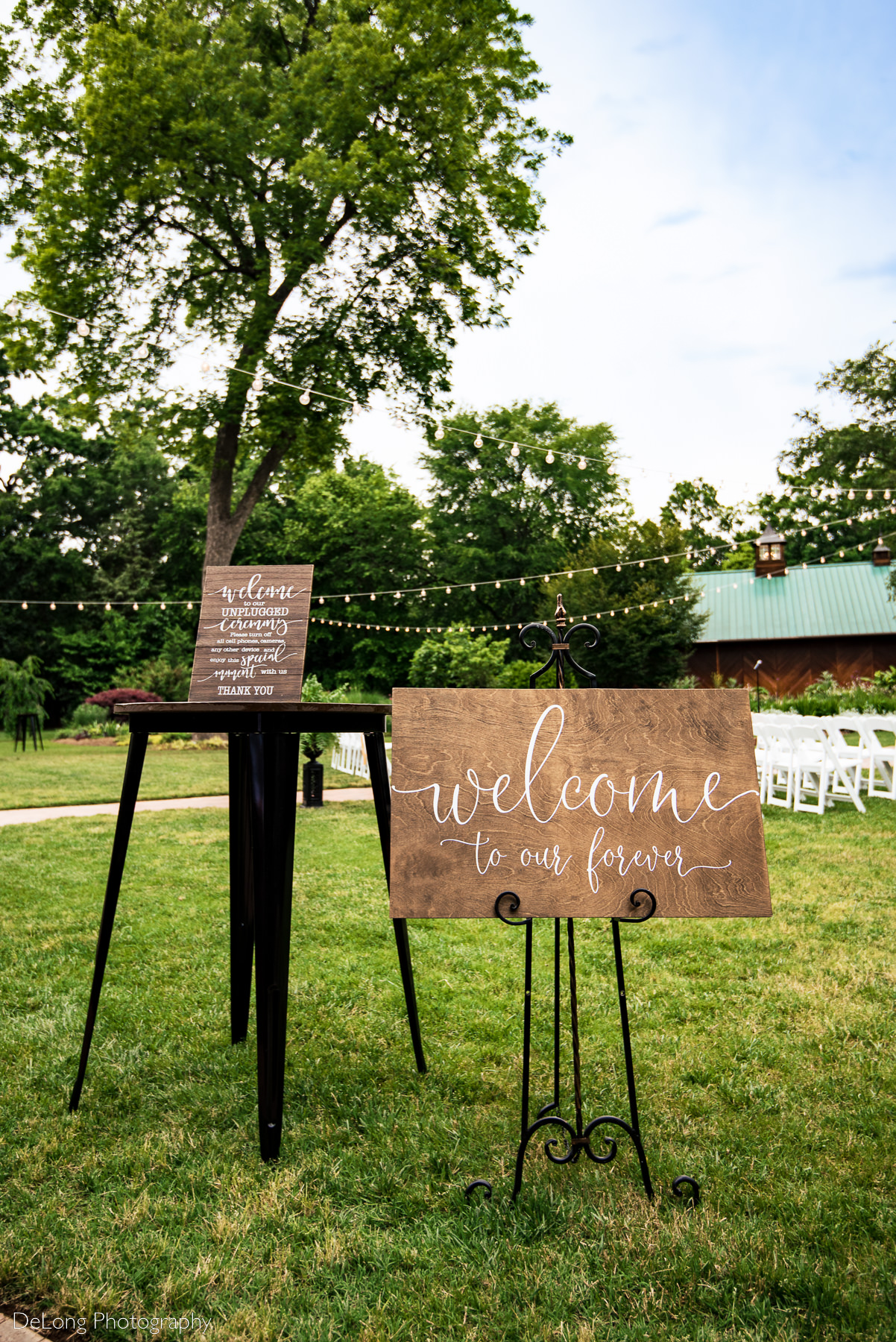 Outdoor wedding ceremony signage at Alexander Homestead. Photograph by Charlotte wedding photographers DeLong Photography.