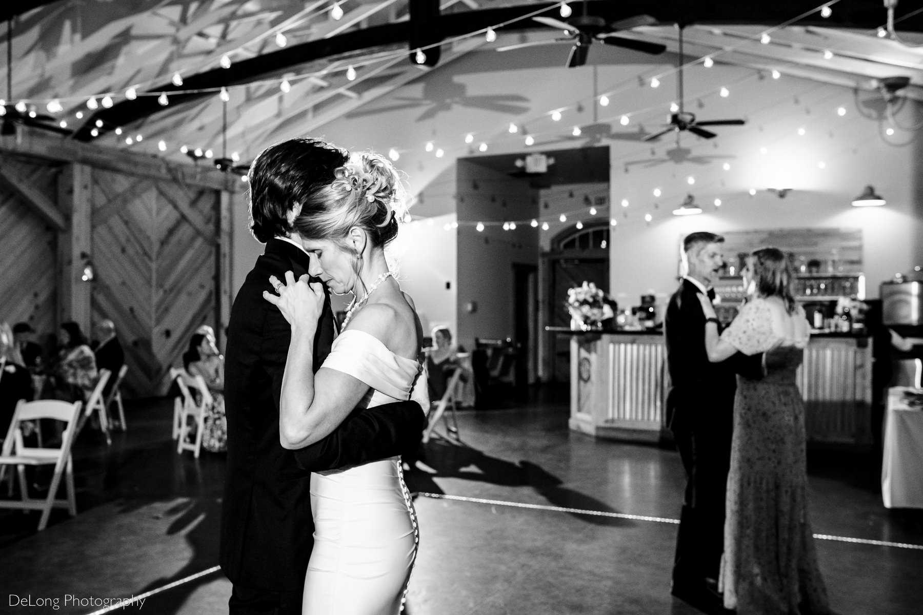 Parents dancing with their children during a special dance during wedding reception at Alexander Homestead. Photograph by Charlotte wedding photographers DeLong Photography.