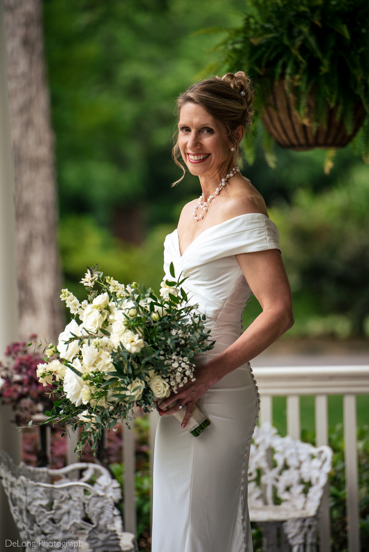 Bridal portrait taken on porch of Alexander Homestead. Photograph by Charlotte wedding photographers DeLong Photography.