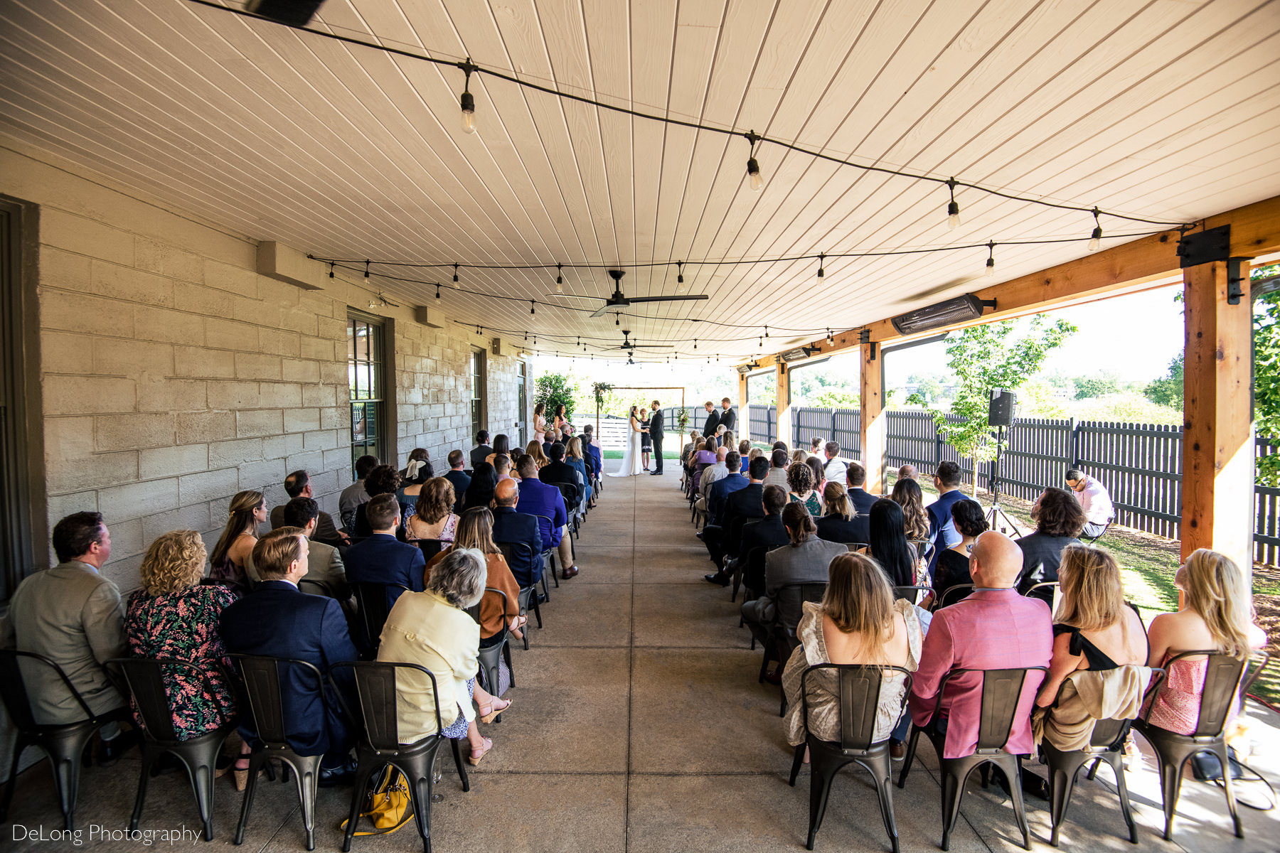 Wide angle photograph of wedding ceremony at Upstairs Atlanta in Atlanta, Georgia. Photograph by Charlotte wedding photographers DeLong Photography.