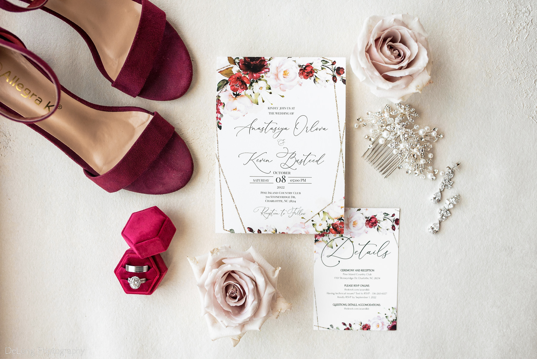 Flat lay of bride's details including shoes, invitation suite, jewelry and accessories in a burgundy and blush color palette at Pine Island Country Club in Charlotte, NC by Charlotte wedding Photographers DeLong Photography