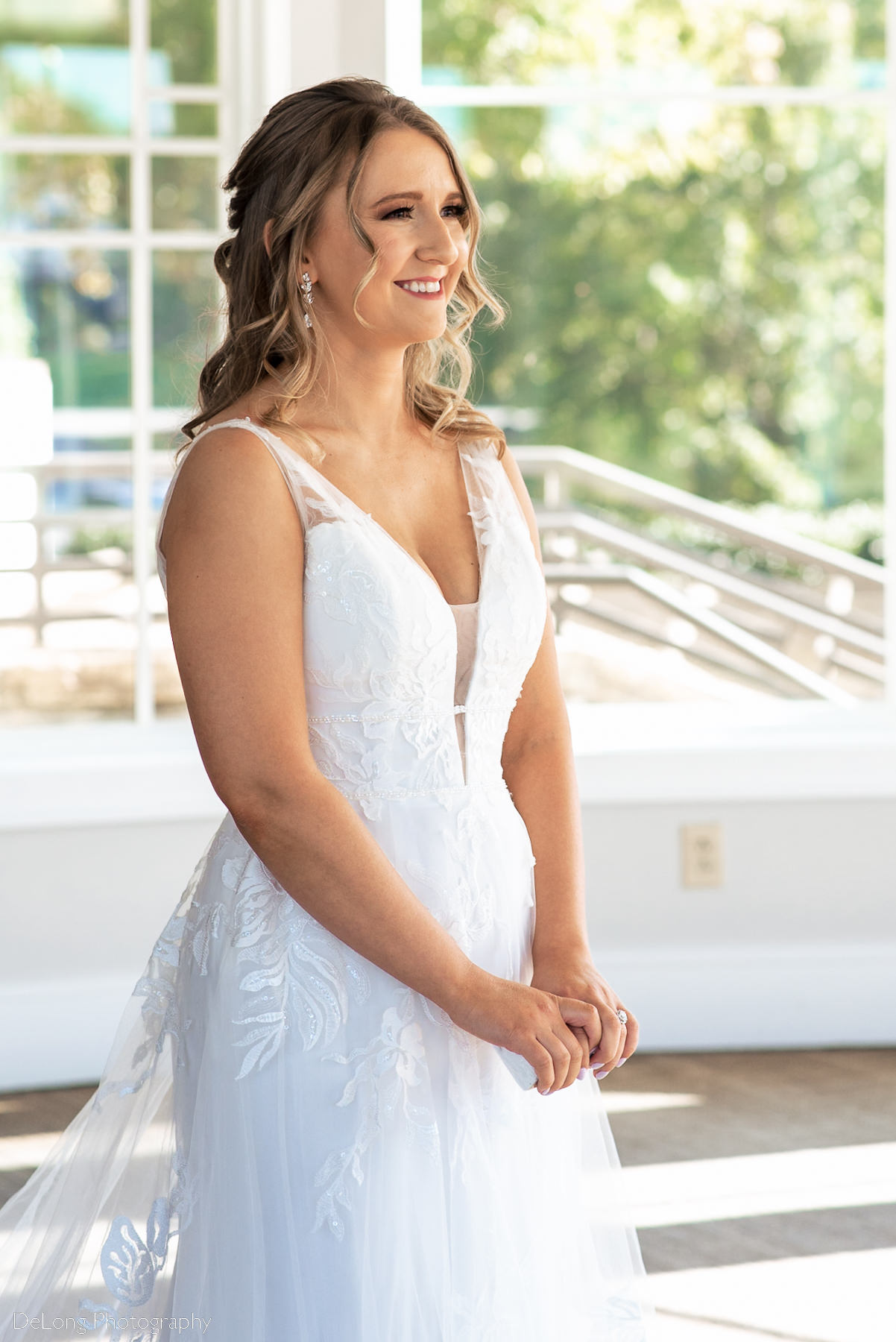 Bride smiling as she approaches her groom before their first look at Pine Island Country Club in Charlotte, NC by Charlotte wedding Photographers DeLong Photography