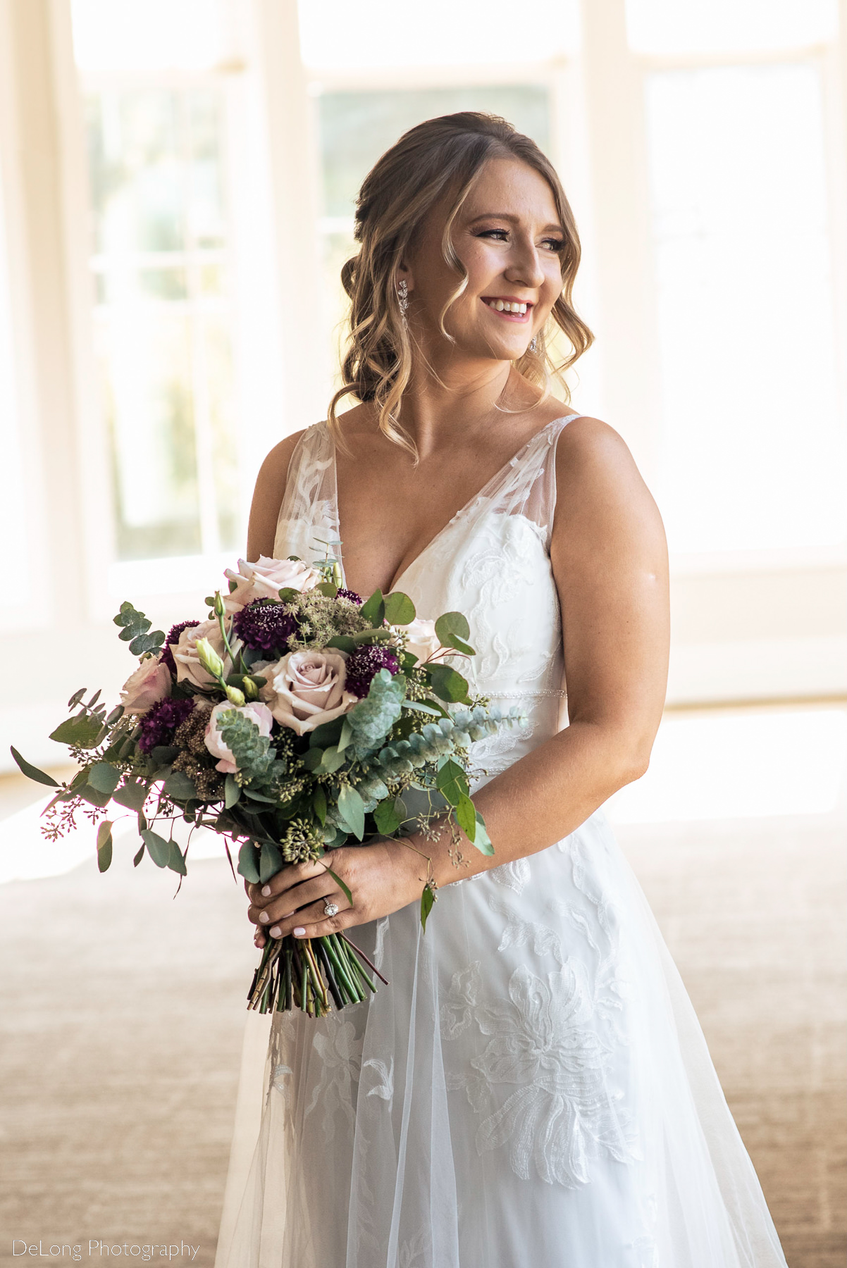 Portrait of bride smiling and laughing indoors at Pine Island Country Club in Charlotte, NC by Charlotte wedding Photographers DeLong Photography
