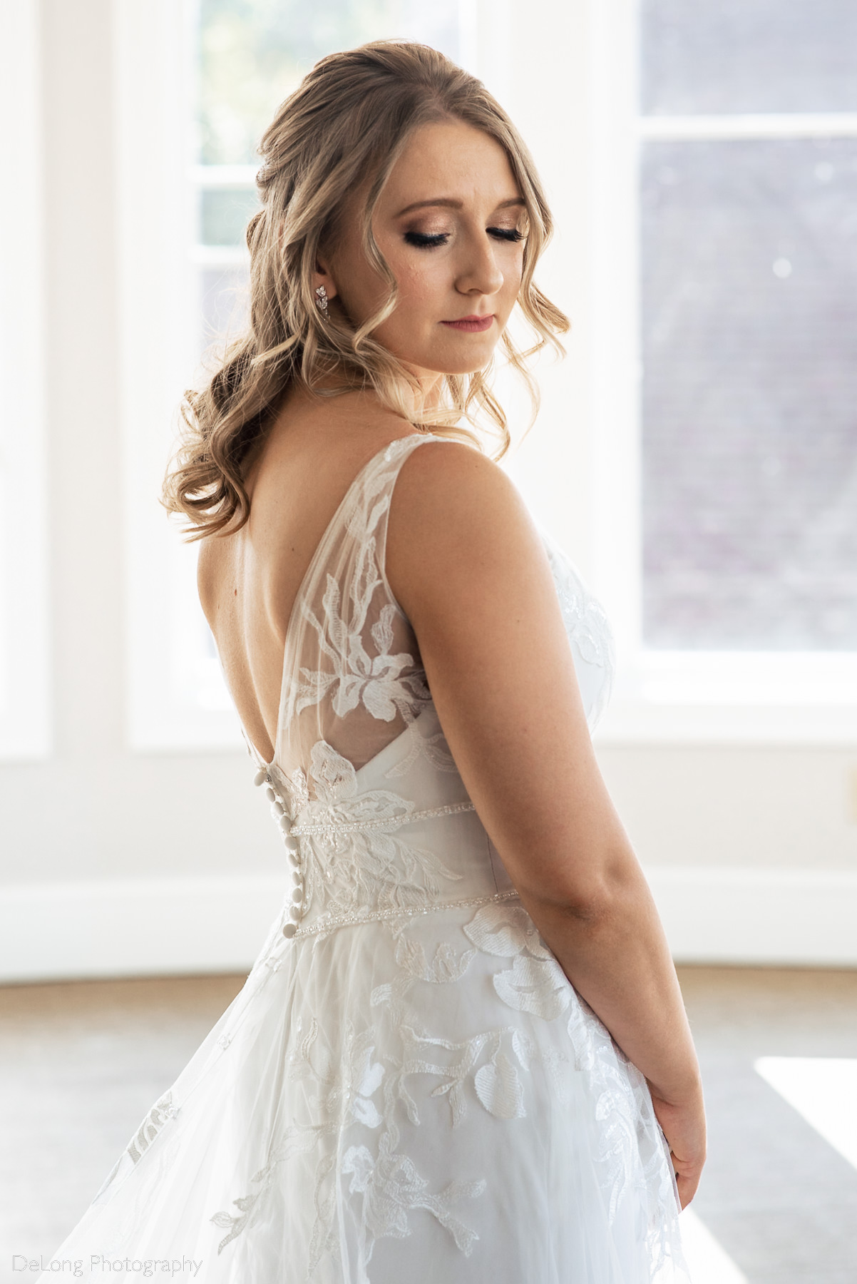 Calm and sweet bridal portrait showing off her makeup and back of her dress at Pine Island Country Club in Charlotte, NC by Charlotte wedding Photographers DeLong Photography