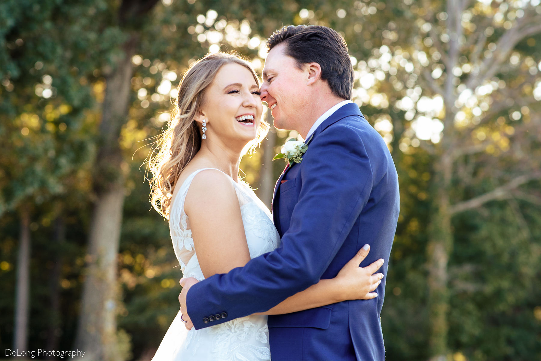 Bride laughing as groom whispers in her ear during sunset at Pine Island Country Club in Charlotte, NC by Charlotte wedding Photographers DeLong Photography