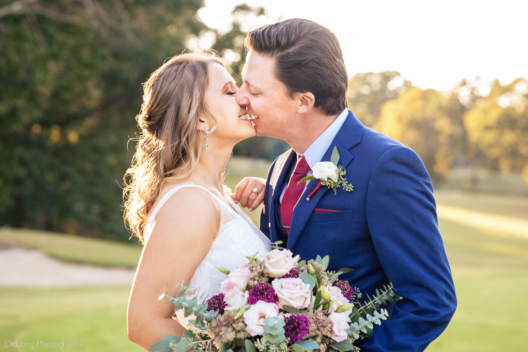 Bride and groom smiling just before kissing on the golf course of Pine Island Country Club in Charlotte, NC by Charlotte wedding Photographers DeLong Photography