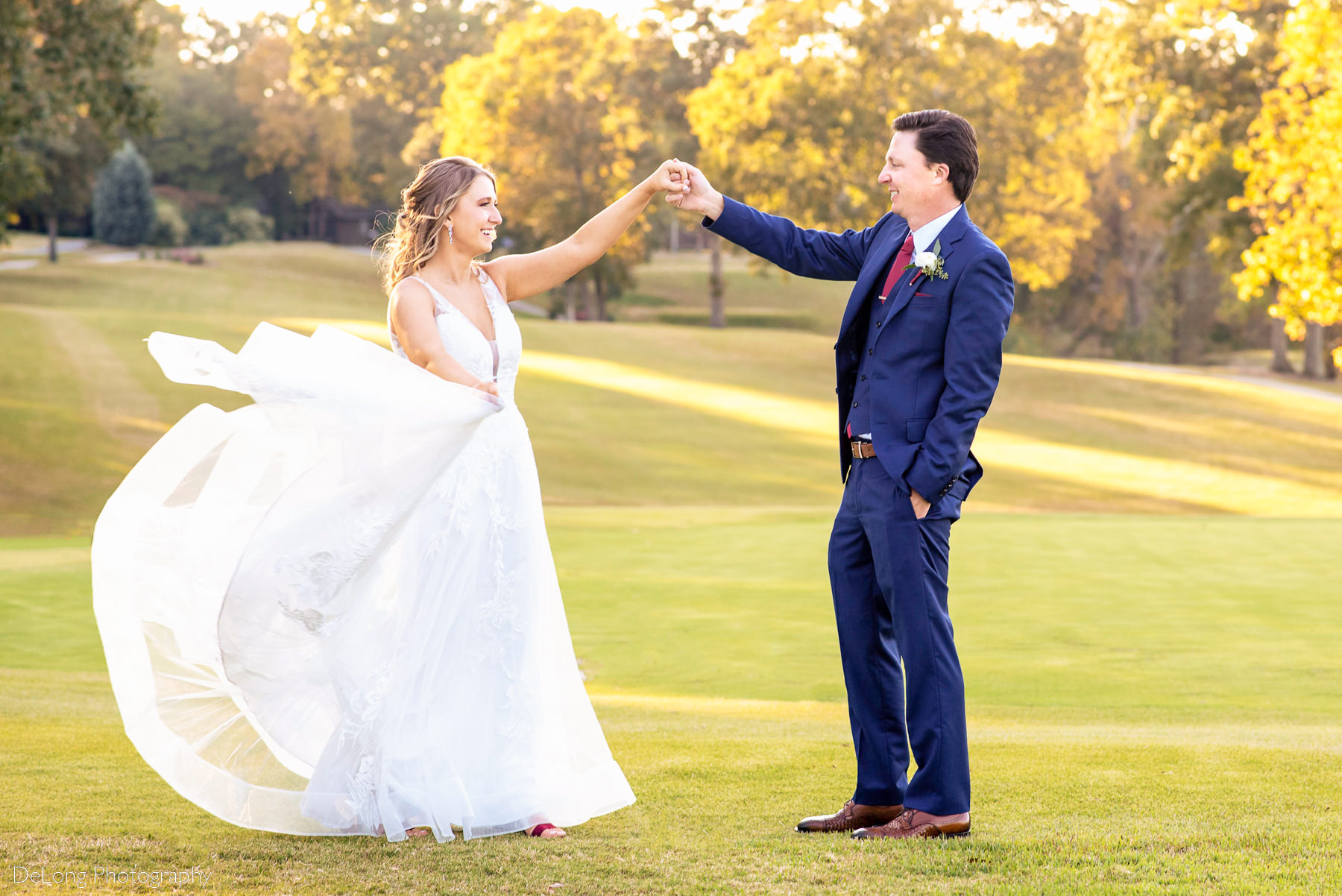 Bride and groom dancing on the gold course with beautiful yellow autumn leaves at Pine Island Country Club in Charlotte, NC by Charlotte wedding Photographers DeLong Photography