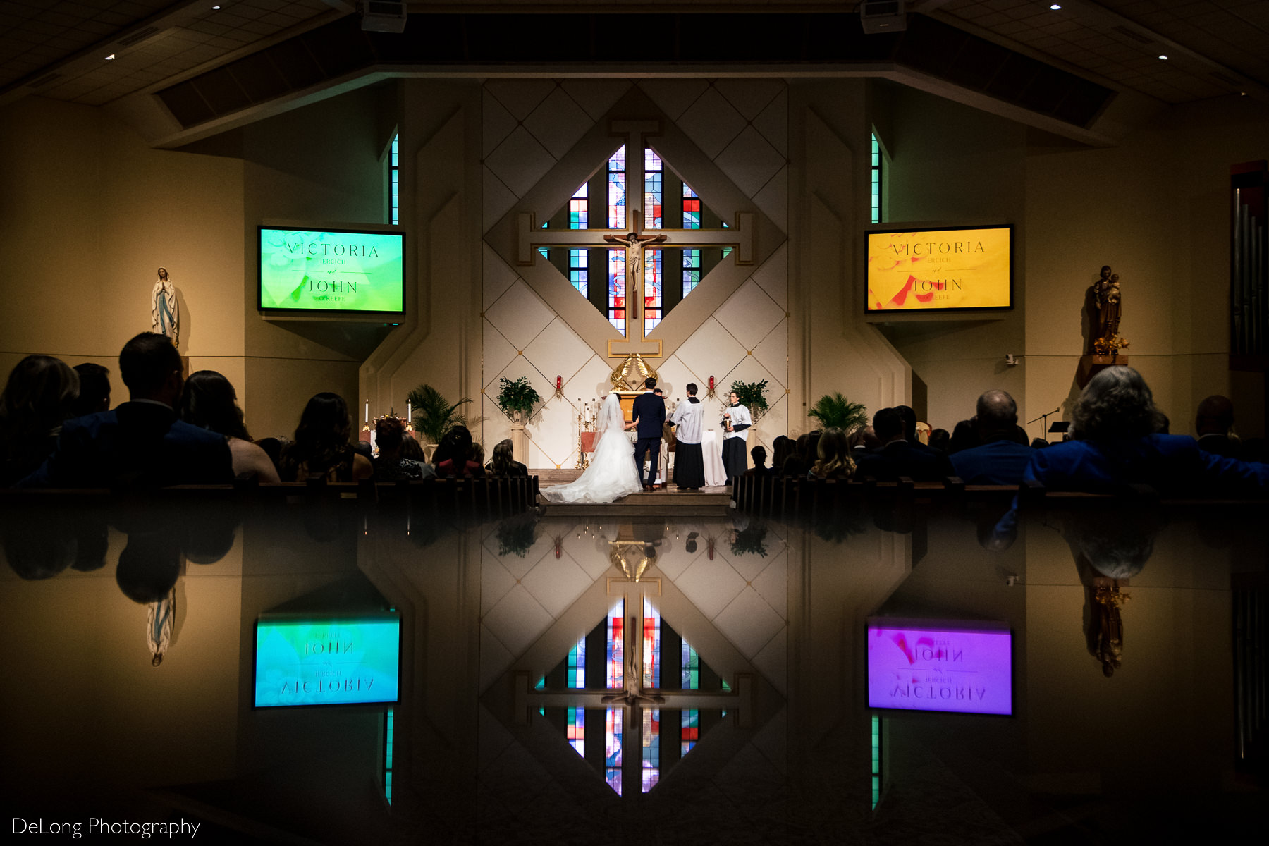 Reflection photograph of bride and groom up on the altar at St Gabriel Catholic Church in Charlotte, NC by Charlotte wedding photographers DeLong Photography