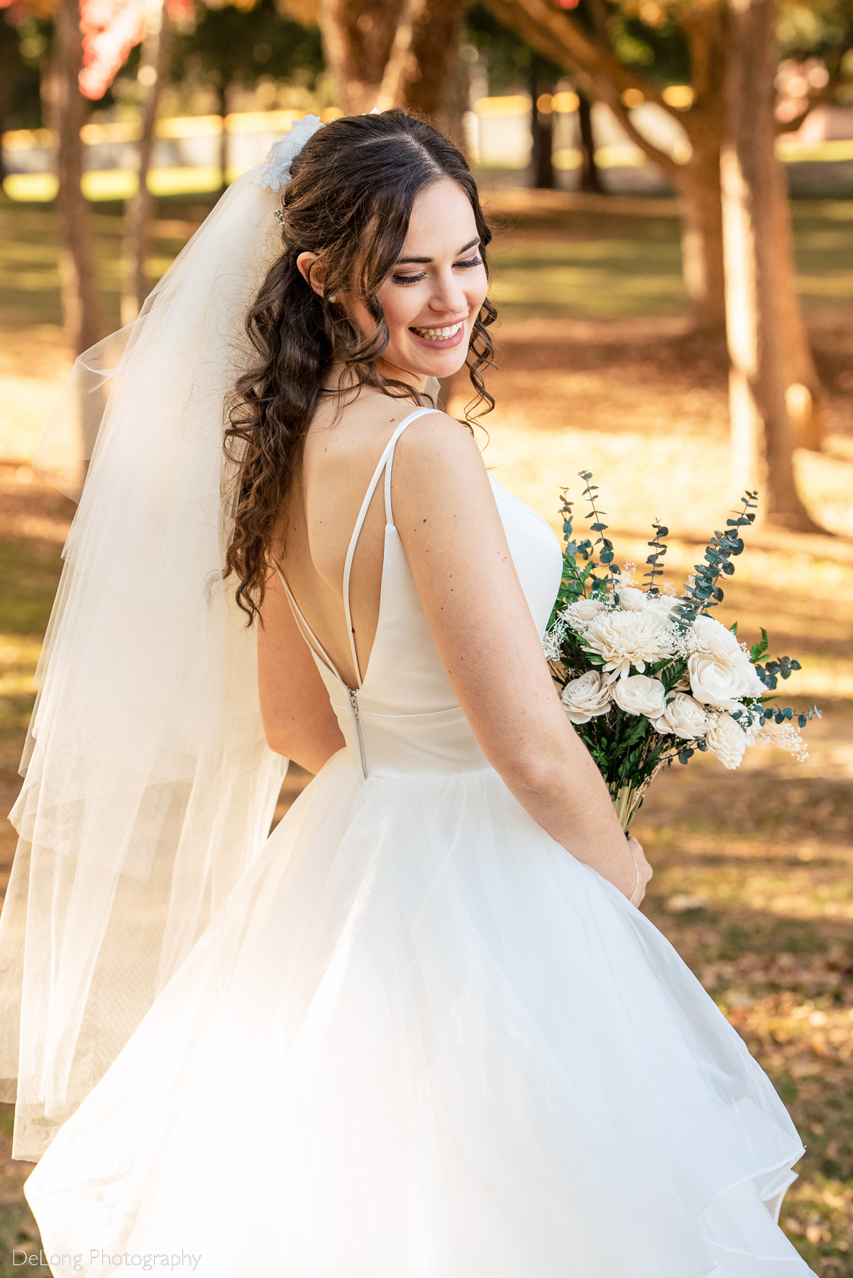 Bridal portrait showing the straps on the back of the dress at Freedom Park by Charlotte wedding photographers DeLong Photography
