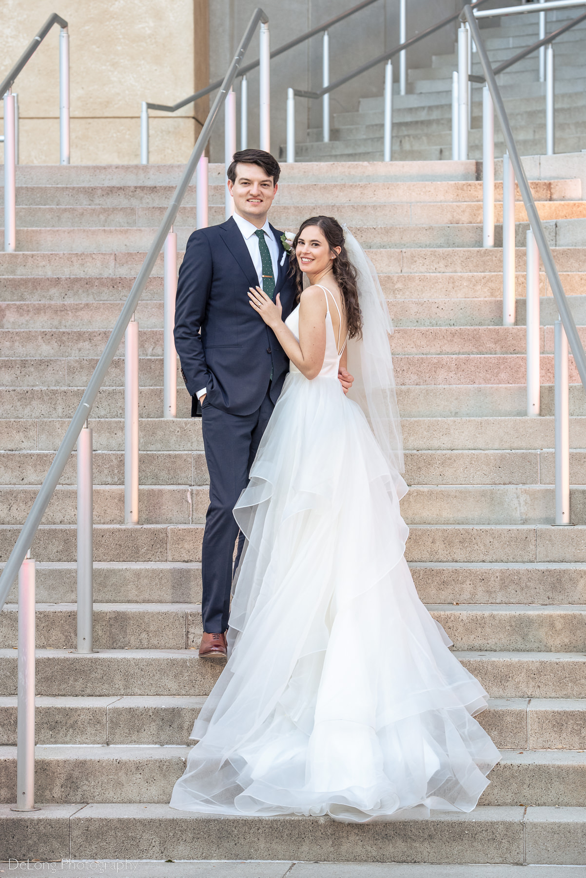 Bride and groom portrait on the steps of the Mint Museum Uptown by Charlotte wedding photographers DeLong Photography