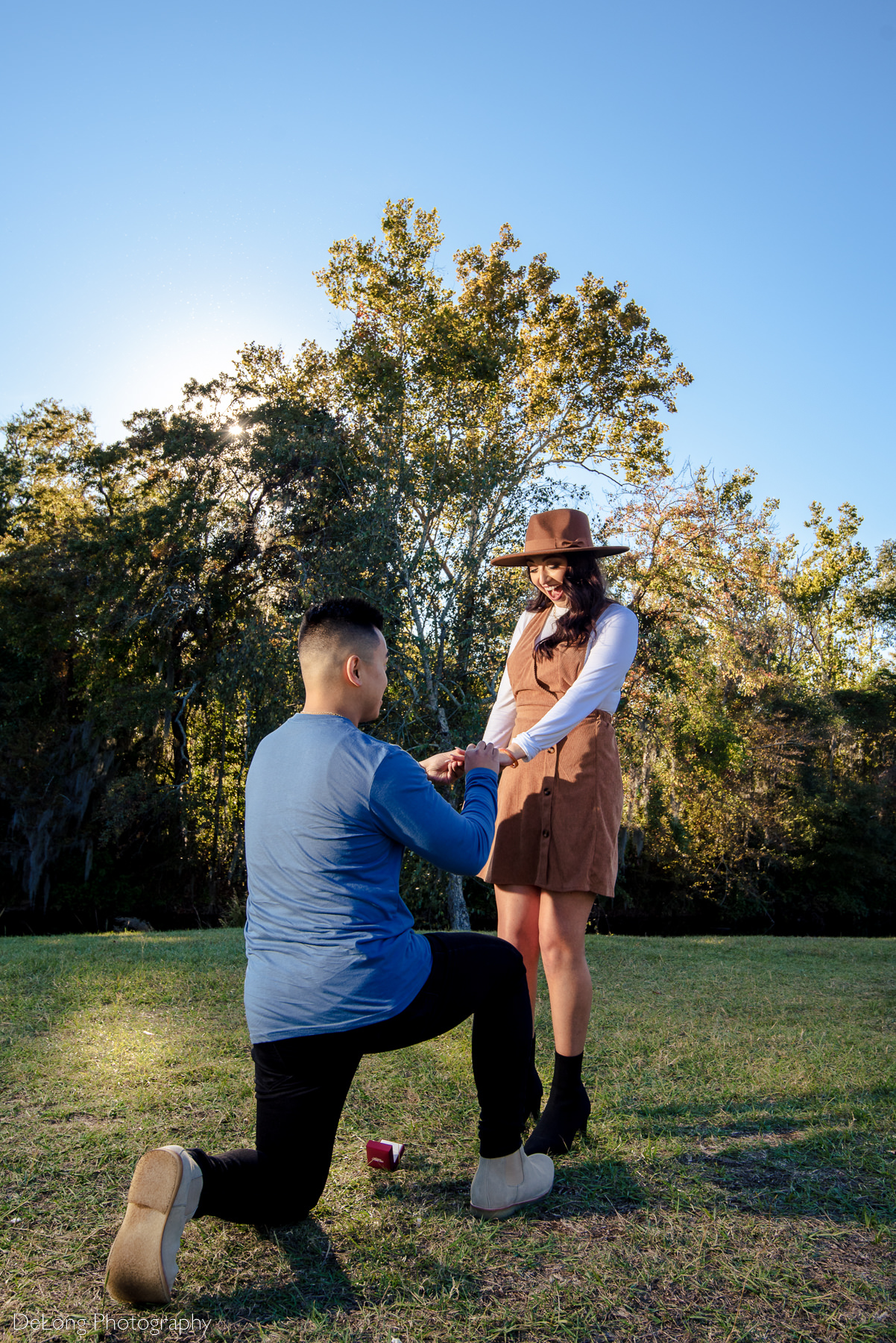 Woman reacting with joy to surprise proposal at Riverfront Park in Columbia, SC. Photo by Charlotte wedding photographers DeLong Photography.