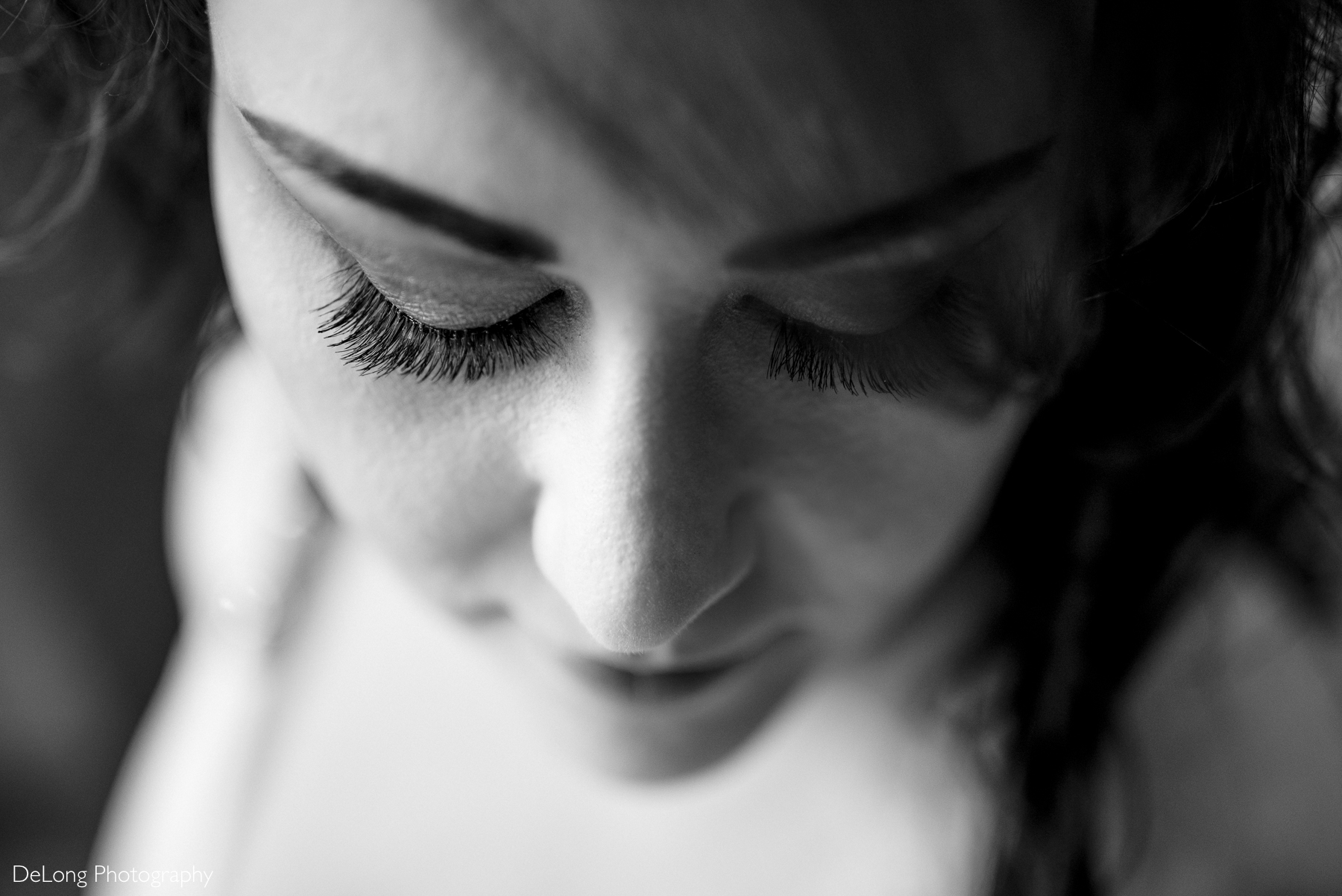 Black and white top-down photograph of the bride's eyelashes. Photograph by Charlotte wedding photographers DeLong Photography taken in the Kimpton Hotel Arras.