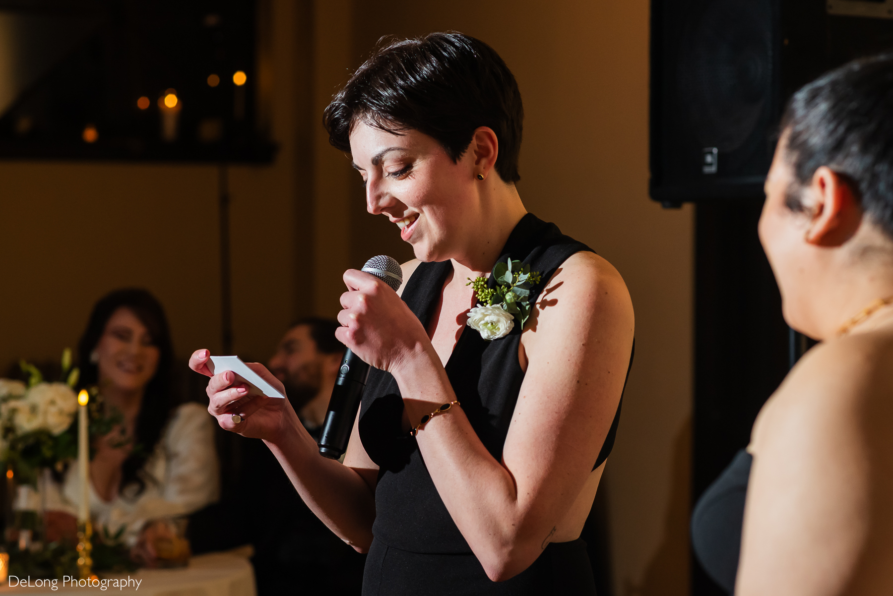 Groom's best person smirking while giving their speech at the reception. Photograph by Charlotte wedding photographers DeLong Photography taken at the Asheville Masonic Temple.