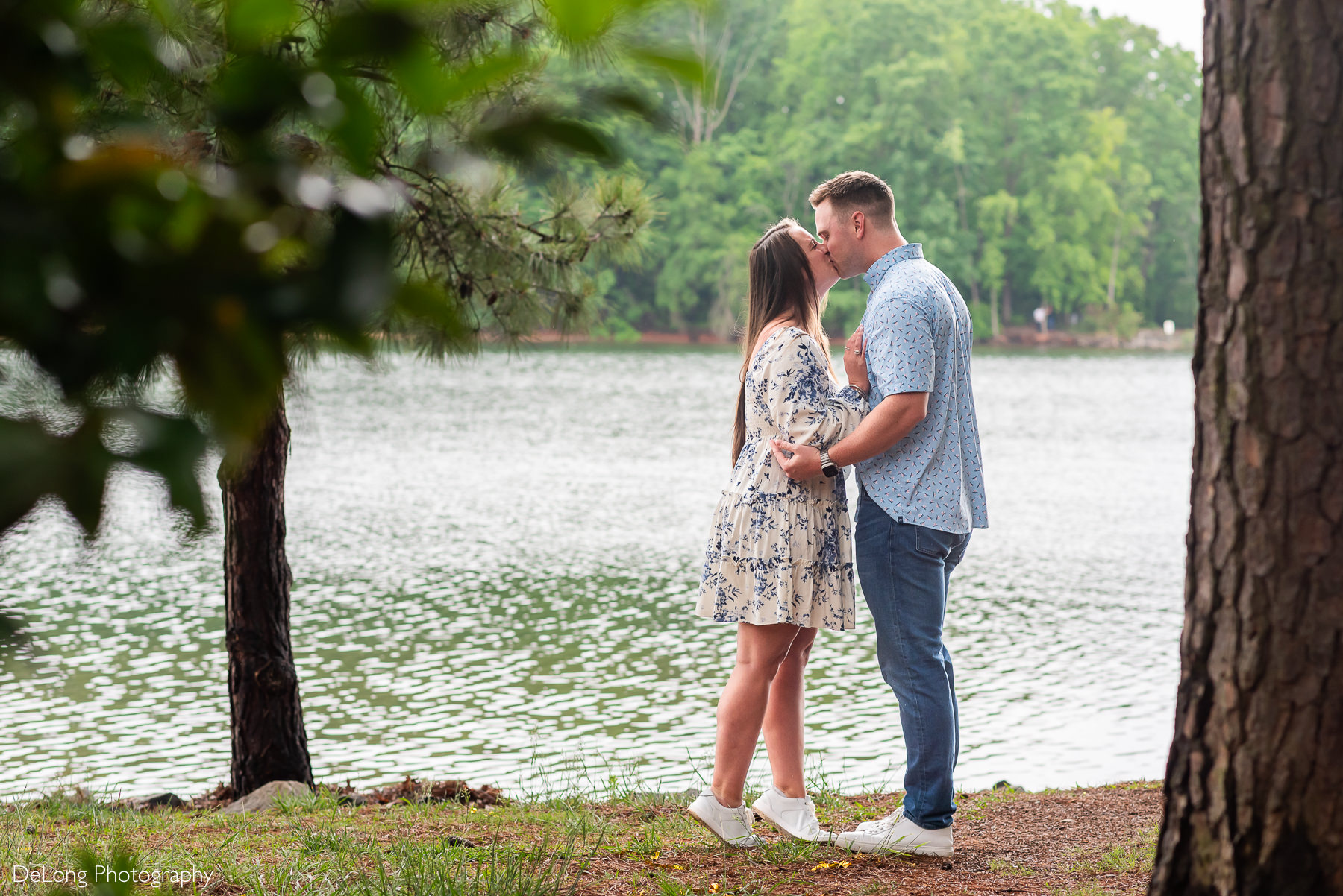 Man and woman sharing a kiss after the woman accepted his wedding proposal.