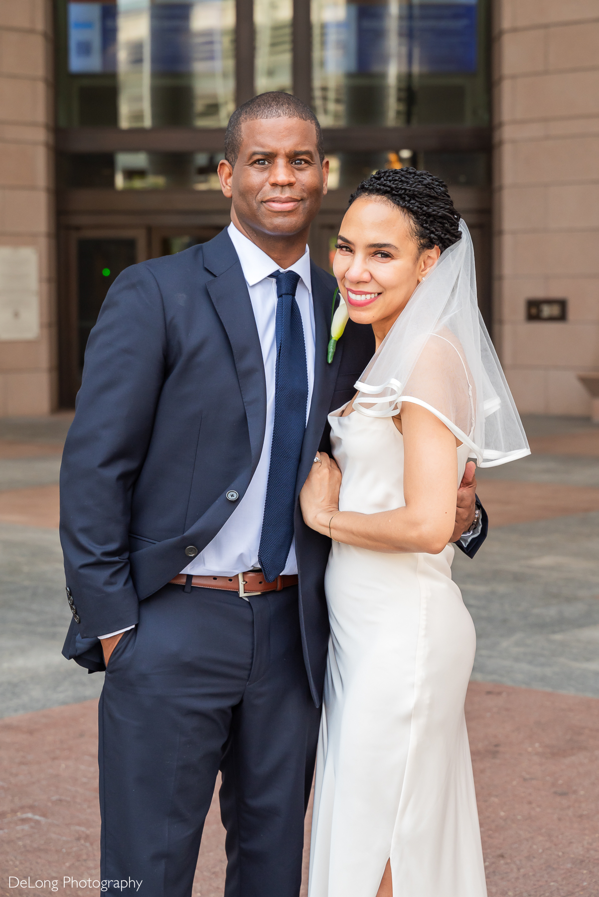 Luxury Charlotte elopement photographer captures a joyful bride and groom outside the Mecklenburg County Courthouse. Perfect inspiration for couples planning a stylish, intimate courthouse wedding in Uptown Charlotte.