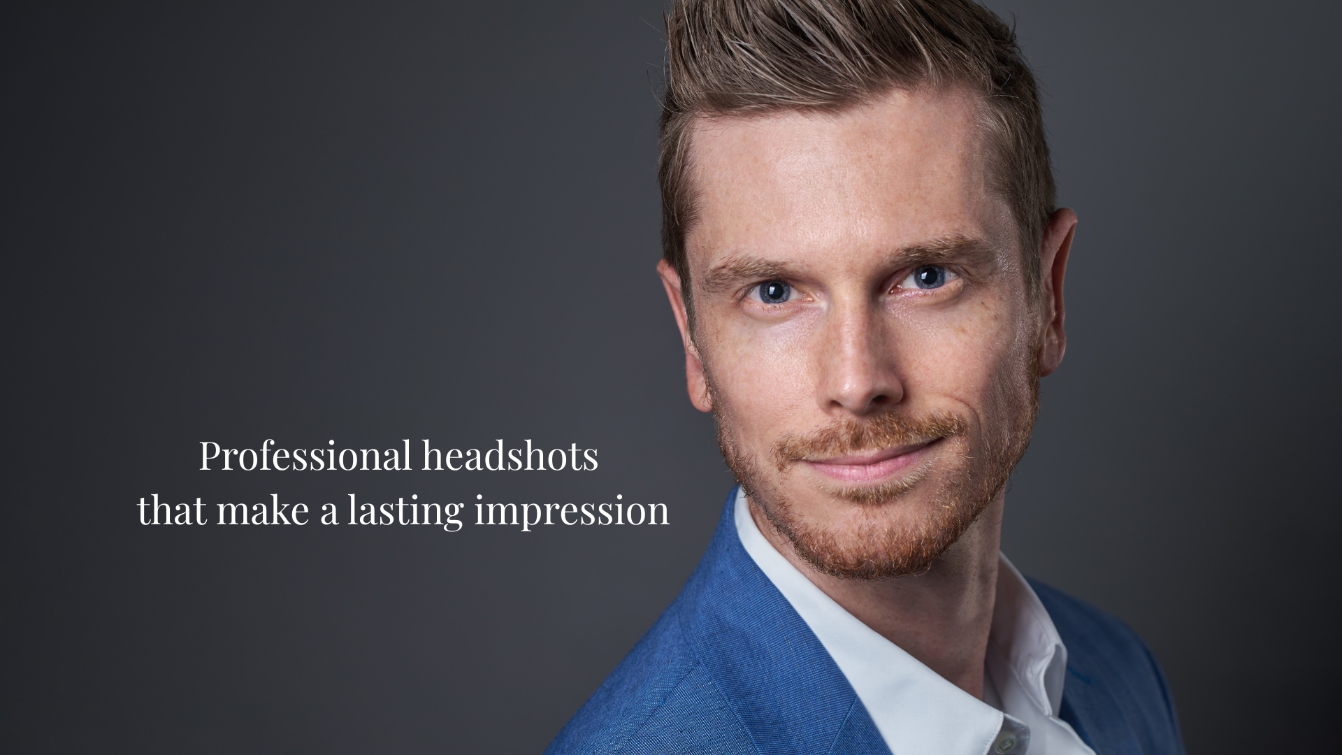 Professional headshot of a man in a blue suit on a gray background with the words "Professional headshots that make a lasting impression" next to him. Captured by Charlotte headshot photographer DeLong Photography.
