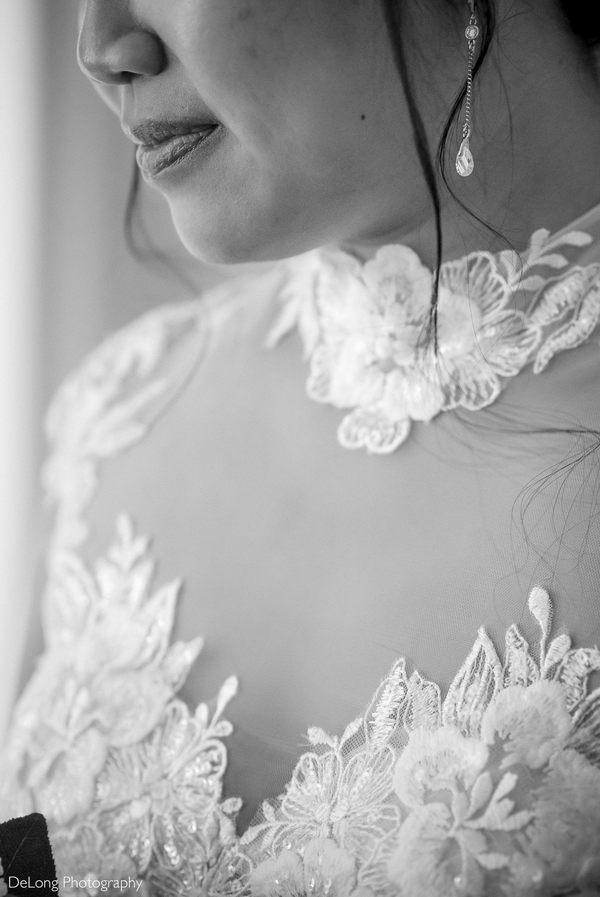 Close-up detail of bride’s Áo Dài-inspired lace neckline and delicate earrings during her Raleigh courthouse elopement, photographed by DeLong Photography.