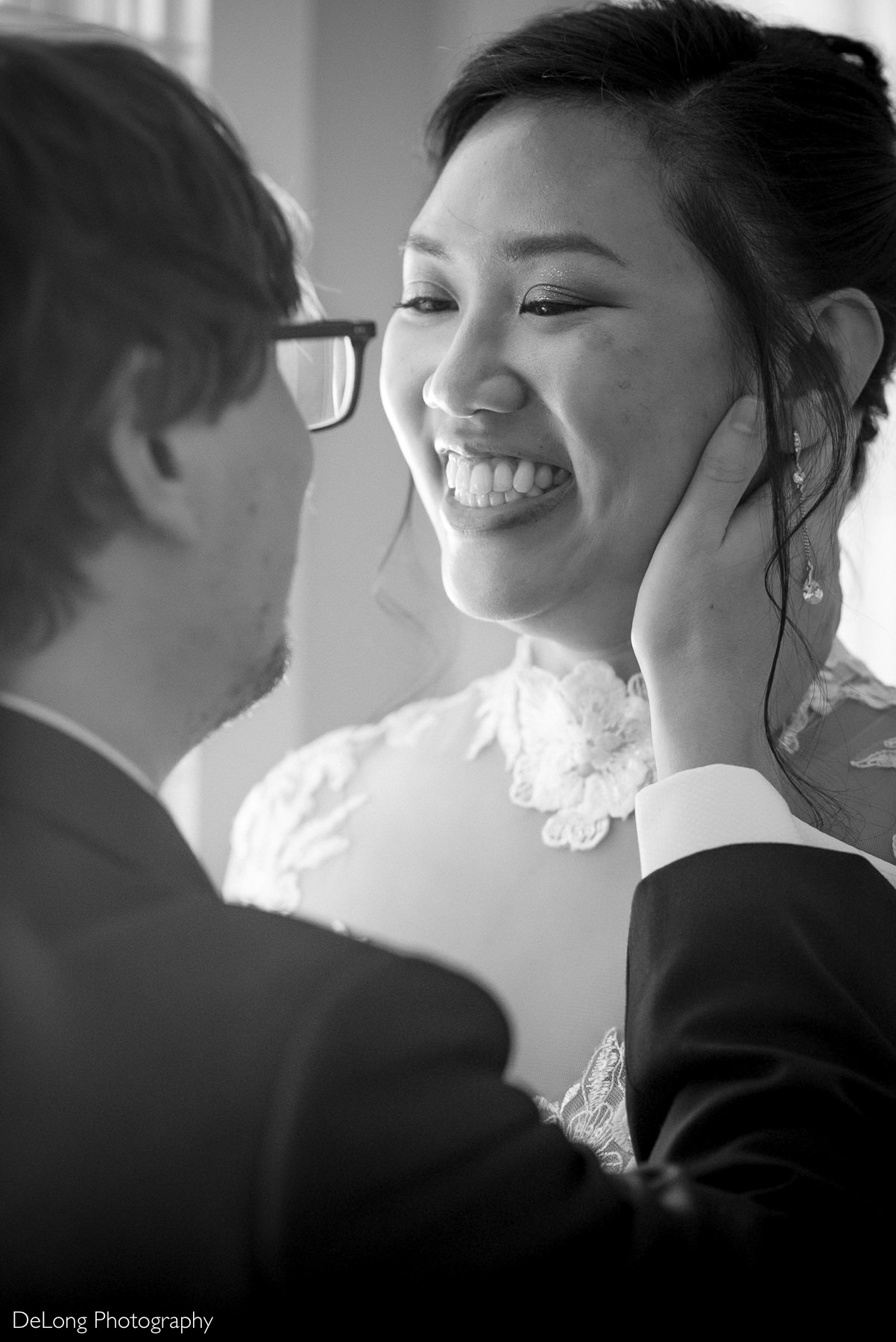 Bride smiling joyfully at her groom during a tender moment before their Raleigh elopement at the Wake County Courthouse, captured by DeLong Photography.