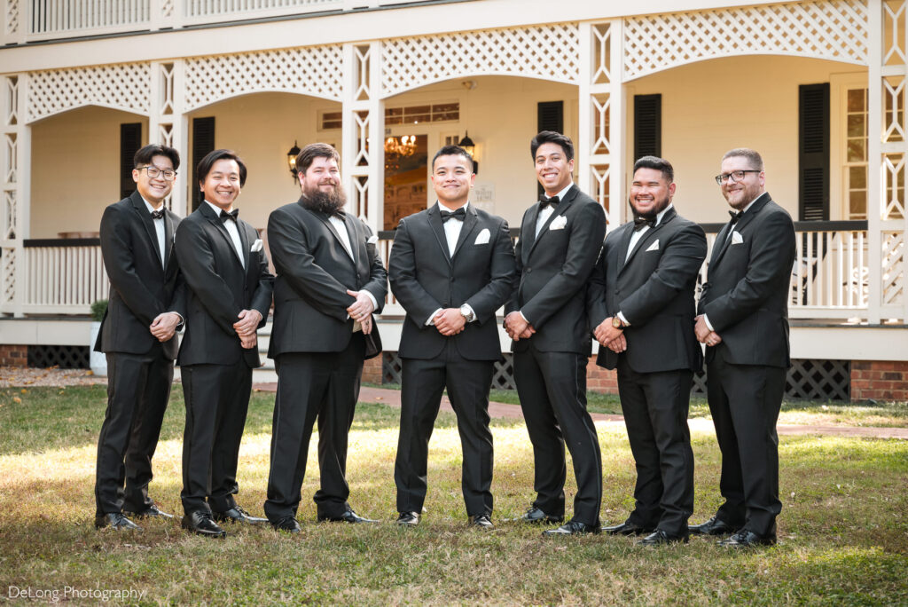 Groom with groomsmen in classic black tuxedos at The White Home in Rock Hill, SC, captured by a professional wedding photographer specializing in timeless wedding portraits.
