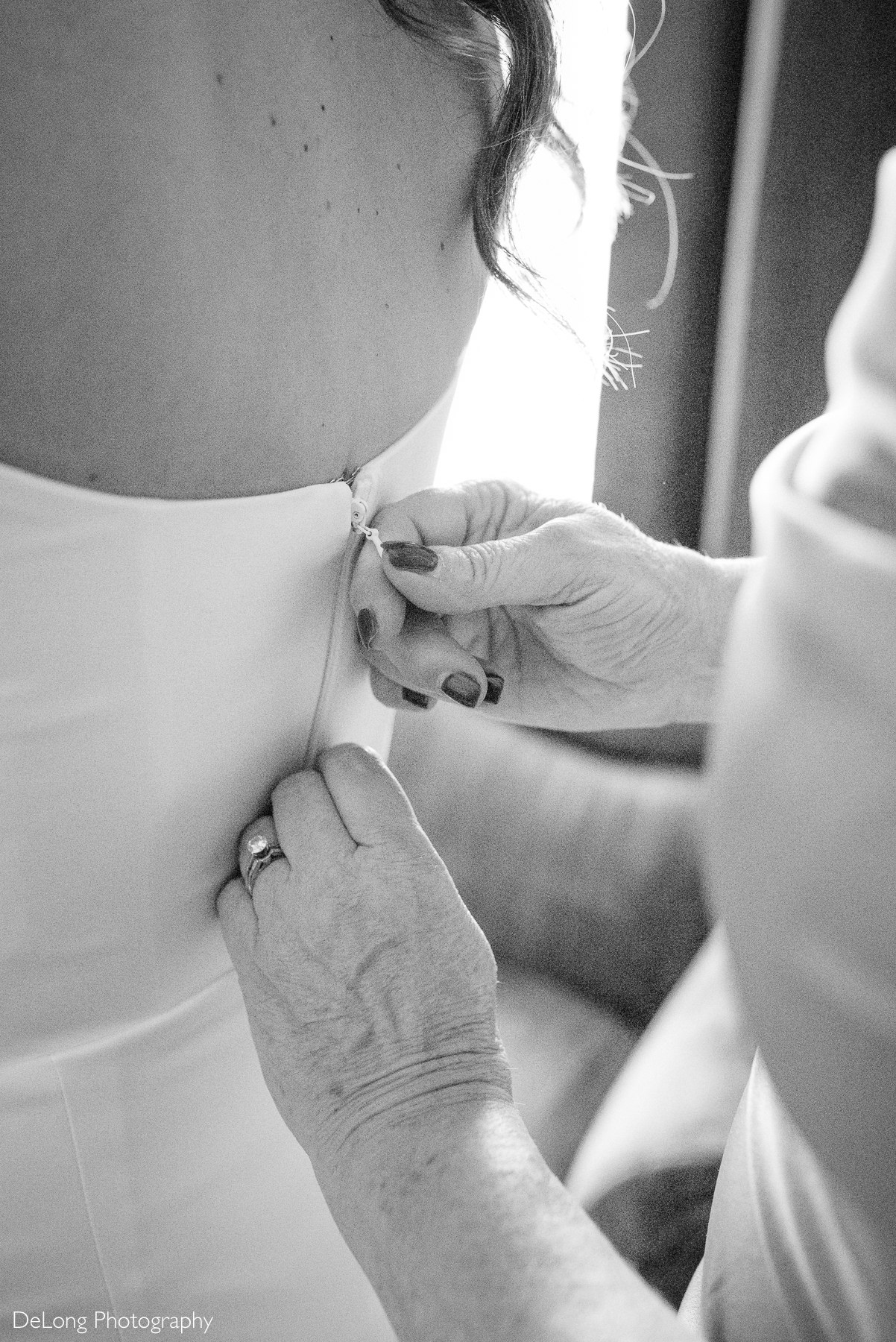 Emotional wedding morning at The White Home in Rock Hill, SC with mother helping bride button her dress, captured by a documentary-style wedding photographer.