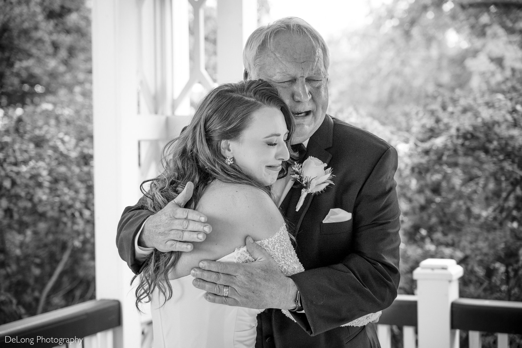 Emotional first look between bride and father at The White Home in Rock Hill, SC. Bride in elegant off-the-shoulder gown embraces her father in tears during a touching wedding day moment at this historic Rock Hill wedding venue.