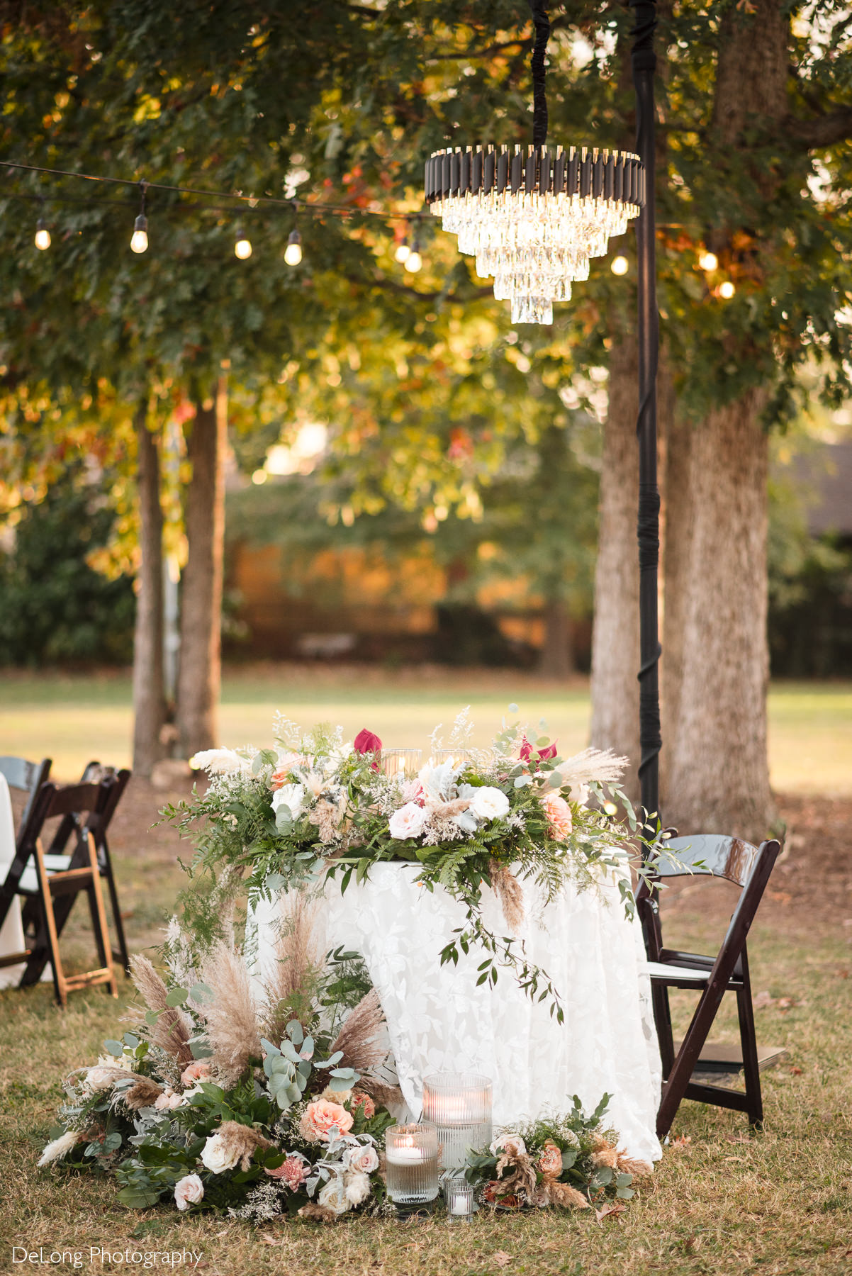 Elegant chandelier lighting above the sweetheart table at The White Home in Rock Hill, South Carolina.