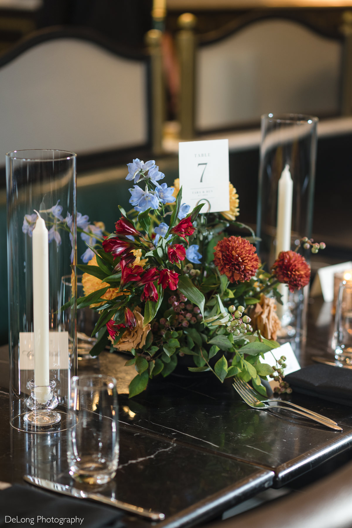 Elegant wedding reception table at La Belle Helene in Uptown Charlotte, NC, featuring lush floral centerpiece, candlelight, and refined place settings—showcasing the French brasserie as a stylish restaurant venue for intimate wedding receptions.