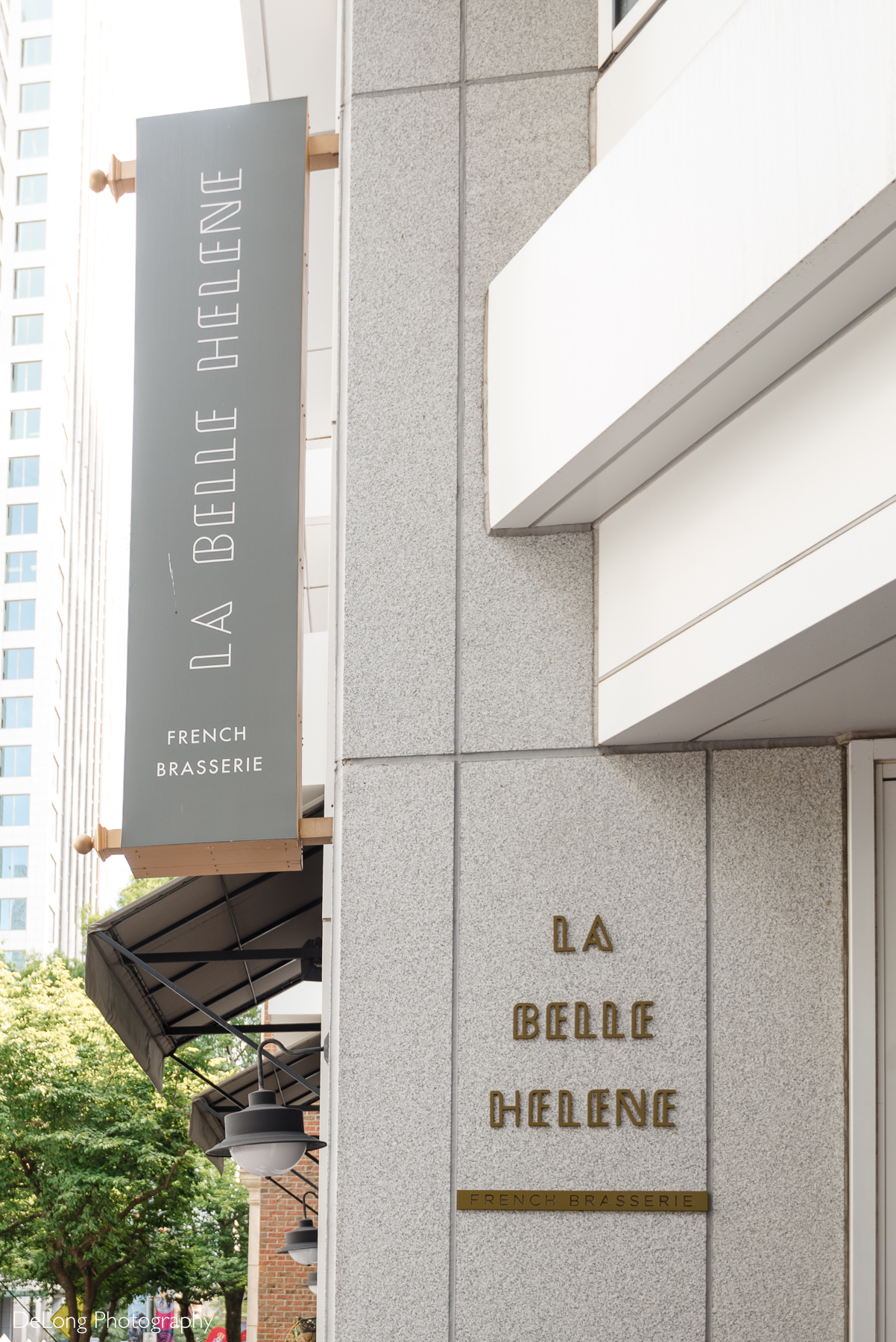 Exterior sign of La Belle Helene French Brasserie in Uptown Charlotte, NC — a stylish restaurant known for hosting intimate wedding receptions and elegant post-ceremony celebrations.