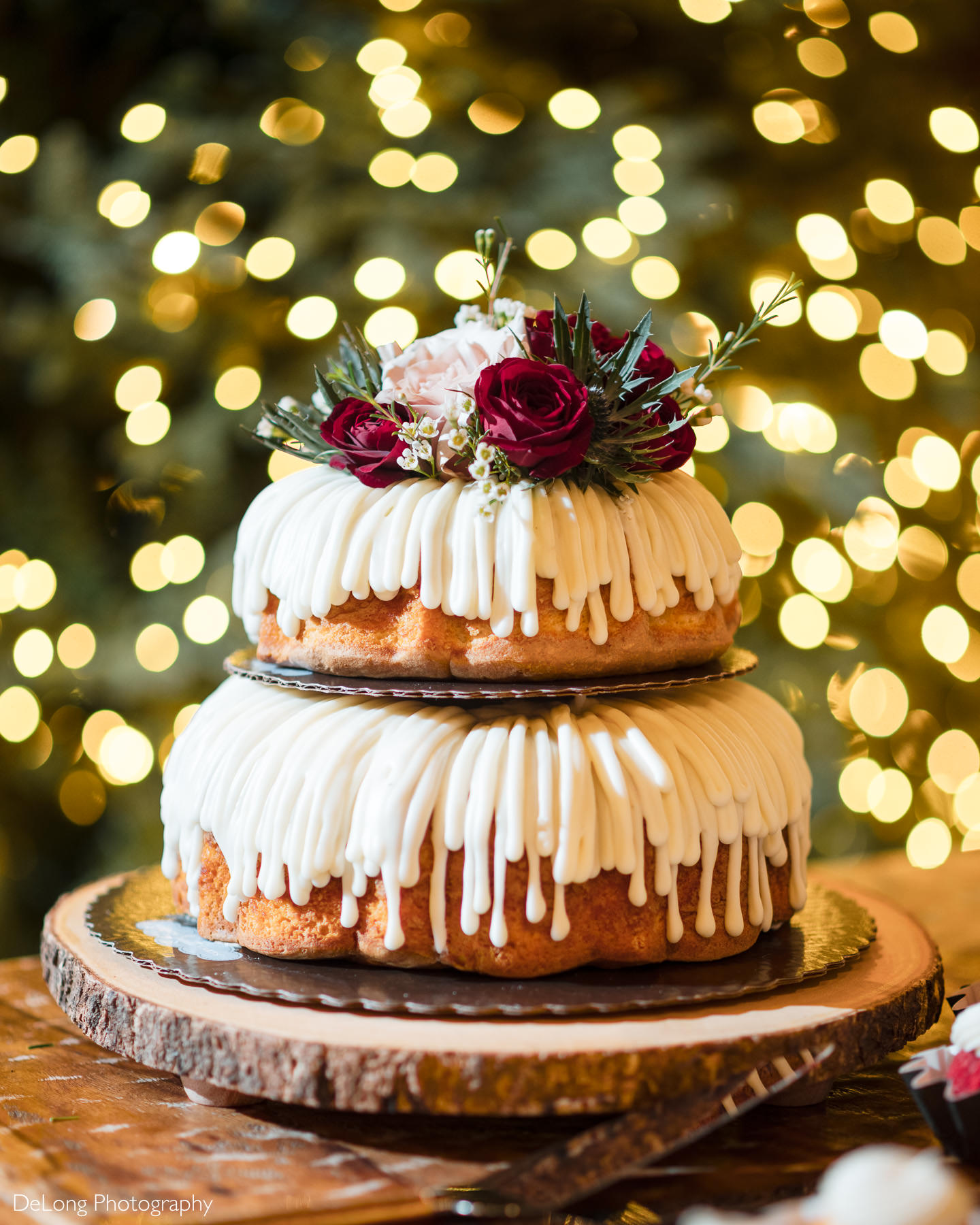 Two-tier rustic wedding cake with white icing and floral topper, displayed at a Childress Vineyards wedding in Lexington, North Carolina.
