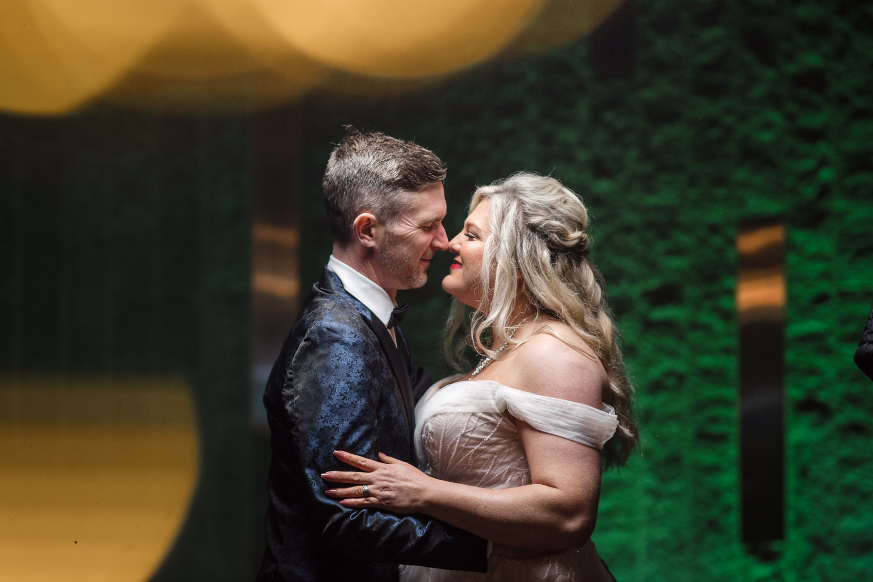 Romantic portrait of a newlywed couple sharing an intimate moment during a Romare Bearden Park elopement in Charlotte, North Carolina, framed by lush greenery and evening light. Emotional elopement photography by DeLong Photography captures the couple’s connection in one of Charlotte’s most iconic parks.