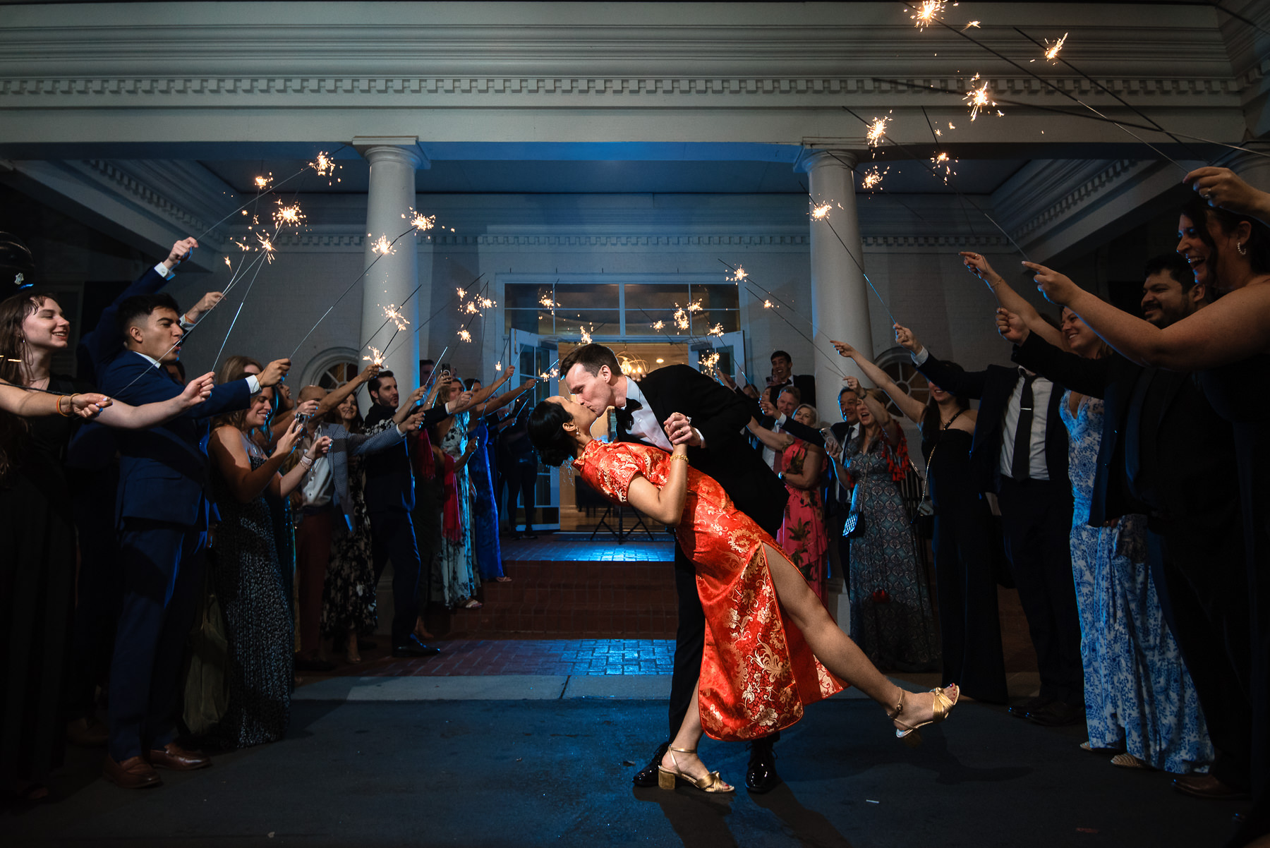 Bride and groom sharing a kiss and dip during their sparkler exit a Providence Country Club, photographed by DeLong Photography, a Charlotte wedding photographer specializing in documentary wedding photography and timeless country club weddings in Charlotte, NC.
