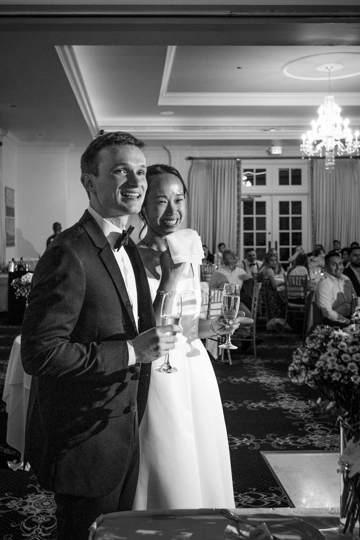 Bride and groom share an emotional champagne toast during their wedding reception at Providence Country Club, captured by DeLong Photography in Charlotte, NC. This elegant candid wedding photography highlights the timeless moments couples search for when looking for Charlotte wedding photographers.