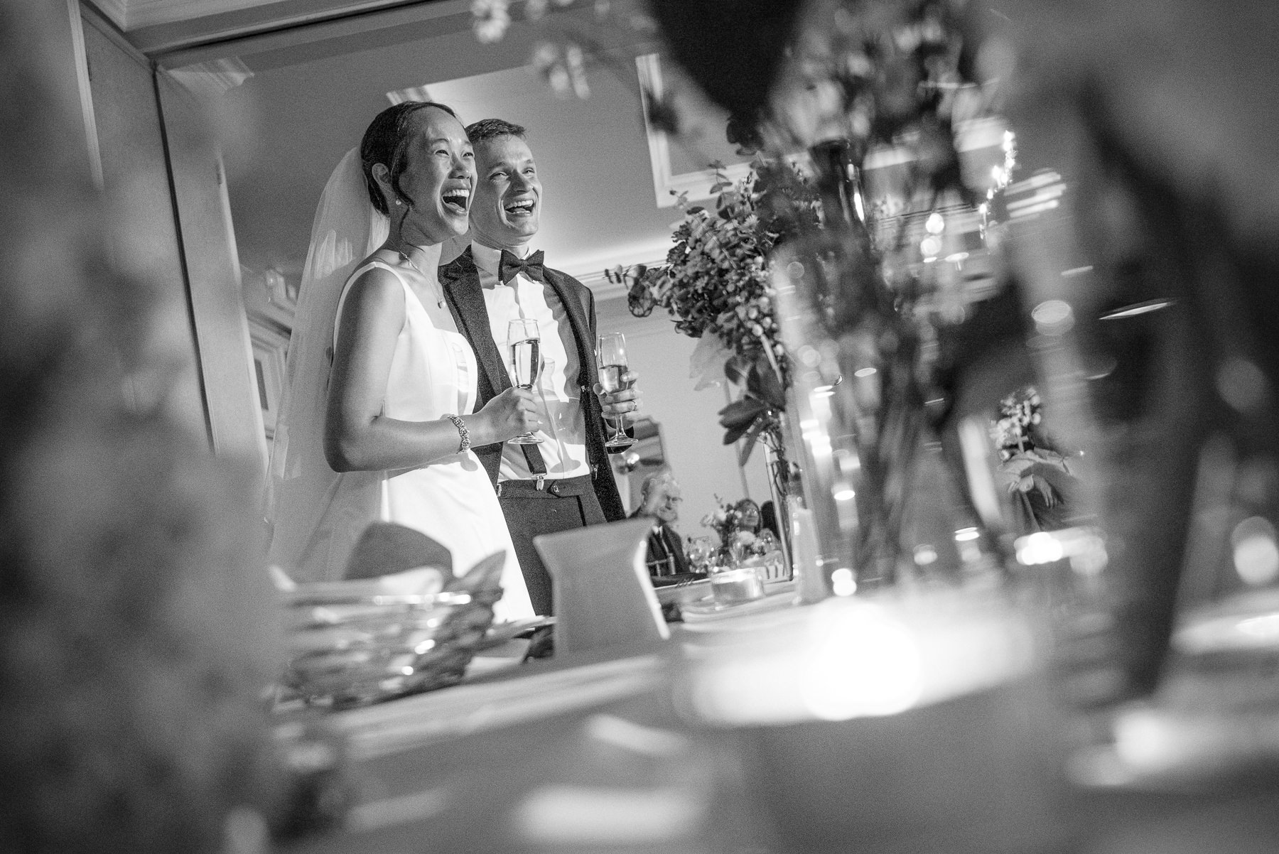 Bride and groom laughing during heartfelt wedding reception toasts at Providence Country Club, photographed by DeLong Photography, a Charlotte wedding photographer specializing in candid wedding photography, emotional moments, and elegant country club weddings in Charlotte, NC.