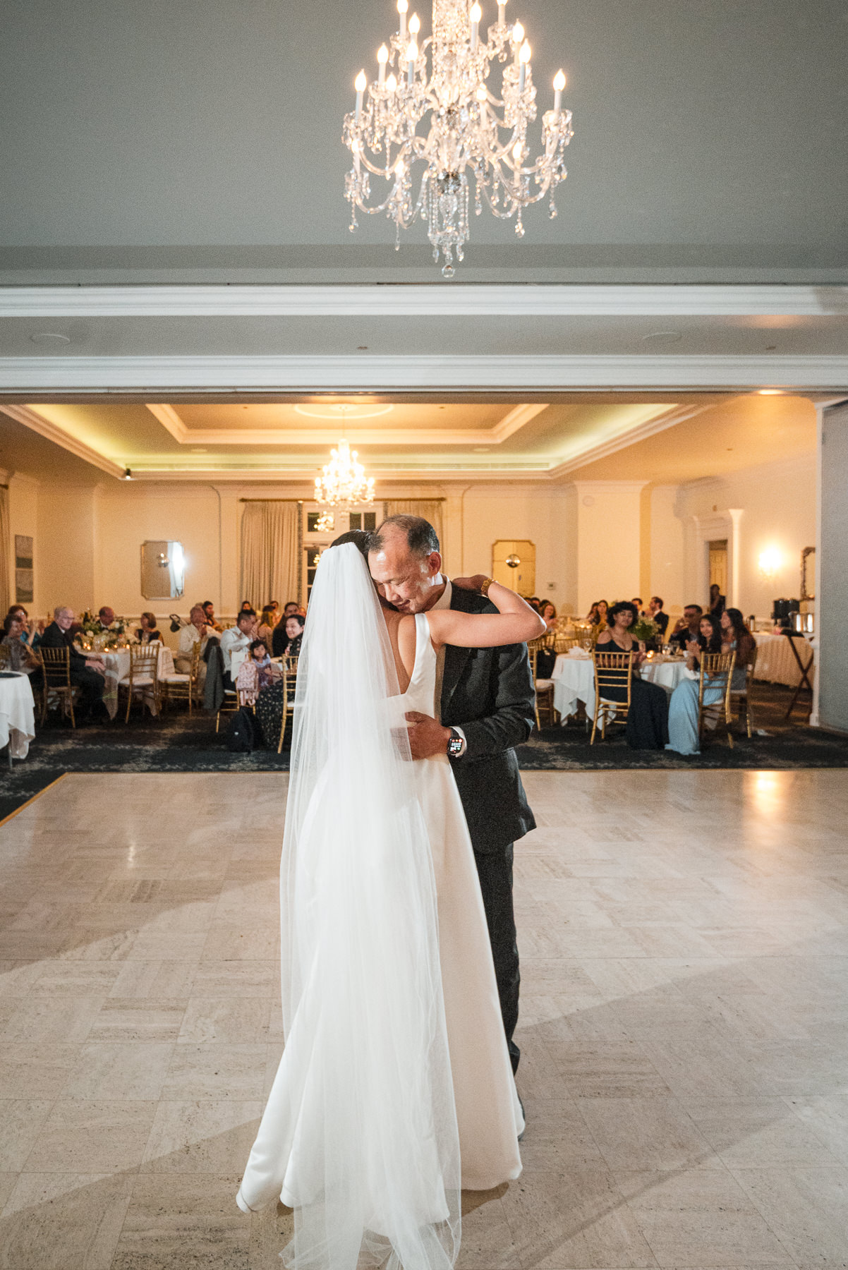Father-of-the bride and bride share an emotional father-daughter dance during their wedding reception at Providence Country Club, photographed by DeLong Photography, a Charlotte wedding photographer specializing in elegant ballroom receptions, candid moments, and timeless wedding photography in Charlotte, NC.