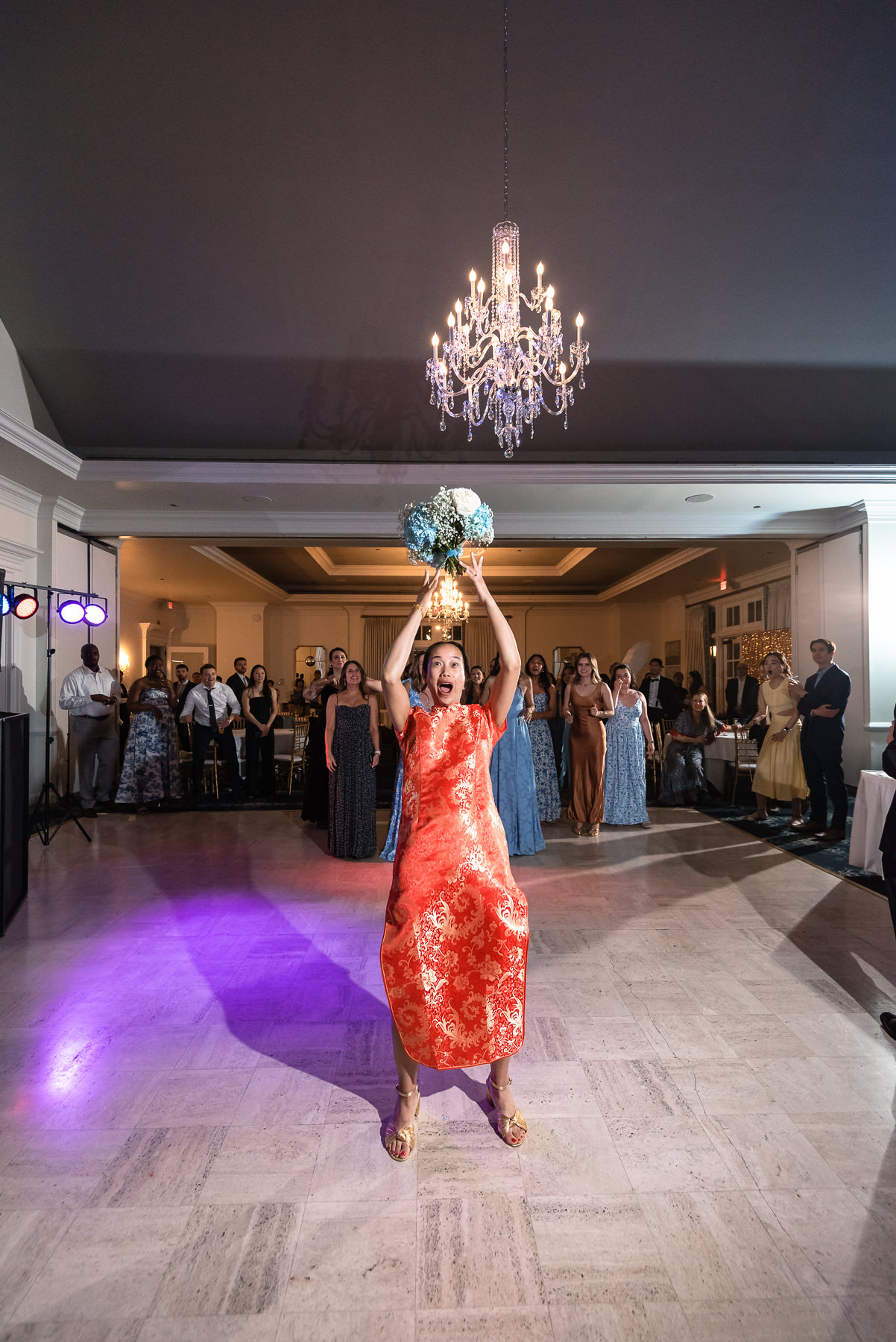 Bouquet toss during an elegant wedding reception at Providence Country Club, photographed by DeLong Photography, a Charlotte wedding photographer specializing in candid wedding photography, lively reception moments, and timeless country club weddings in Charlotte, NC.