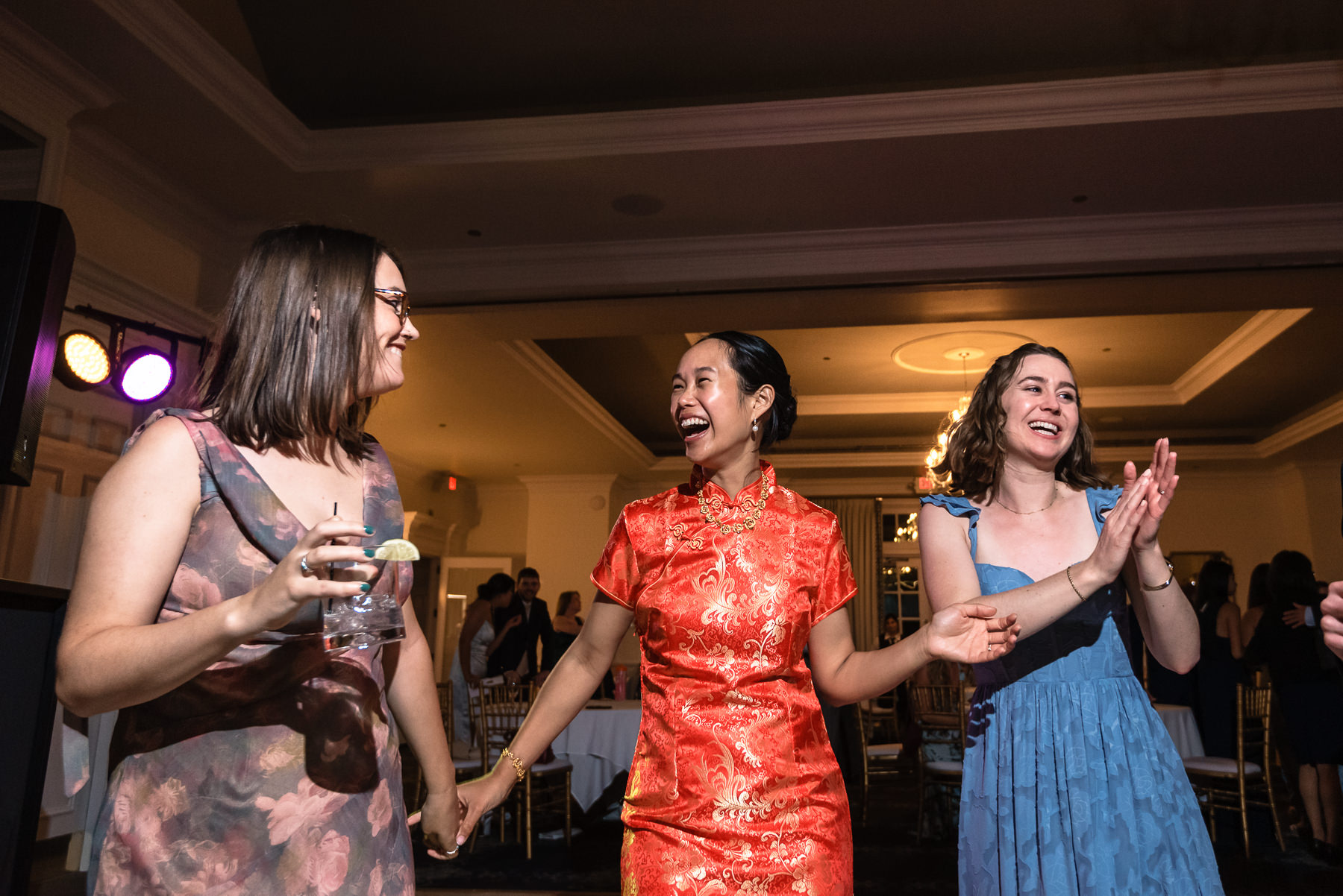 Bride enjoying the dance floor with friends during her elegant wedding reception at Providence Country Club, photographed by DeLong Photography, a Charlotte wedding photographer specializing in candid wedding photography and timeless country club weddings in Charlotte, NC.