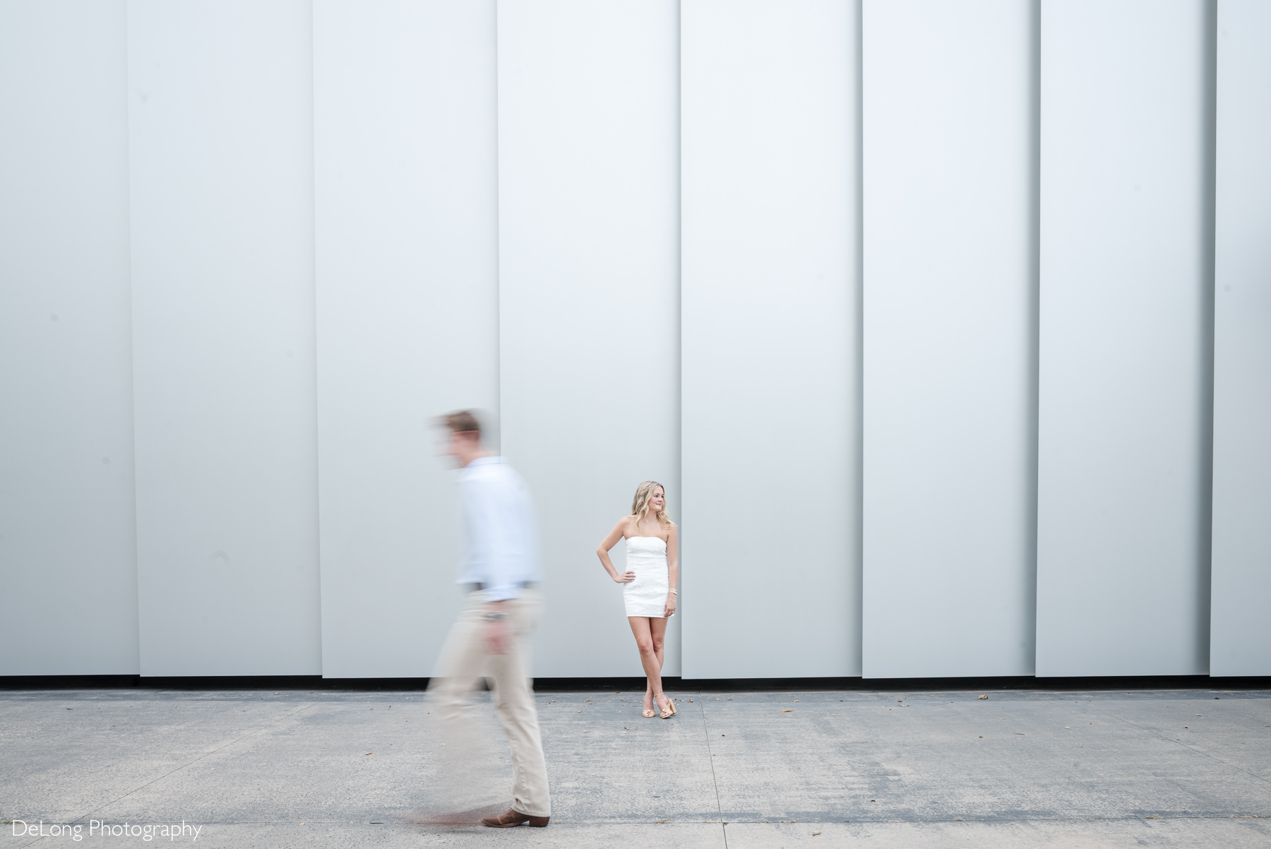 Raleigh engagement photographer capturing a creative engagement session at the North Carolina Museum of Art, featuring a couple framed by the museum’s modern architecture and clean geometric lines. Artistic engagement photography by DeLong Photography, documenting authentic moments for couples seeking a Raleigh engagement photographer and unique North Carolina engagement photos.